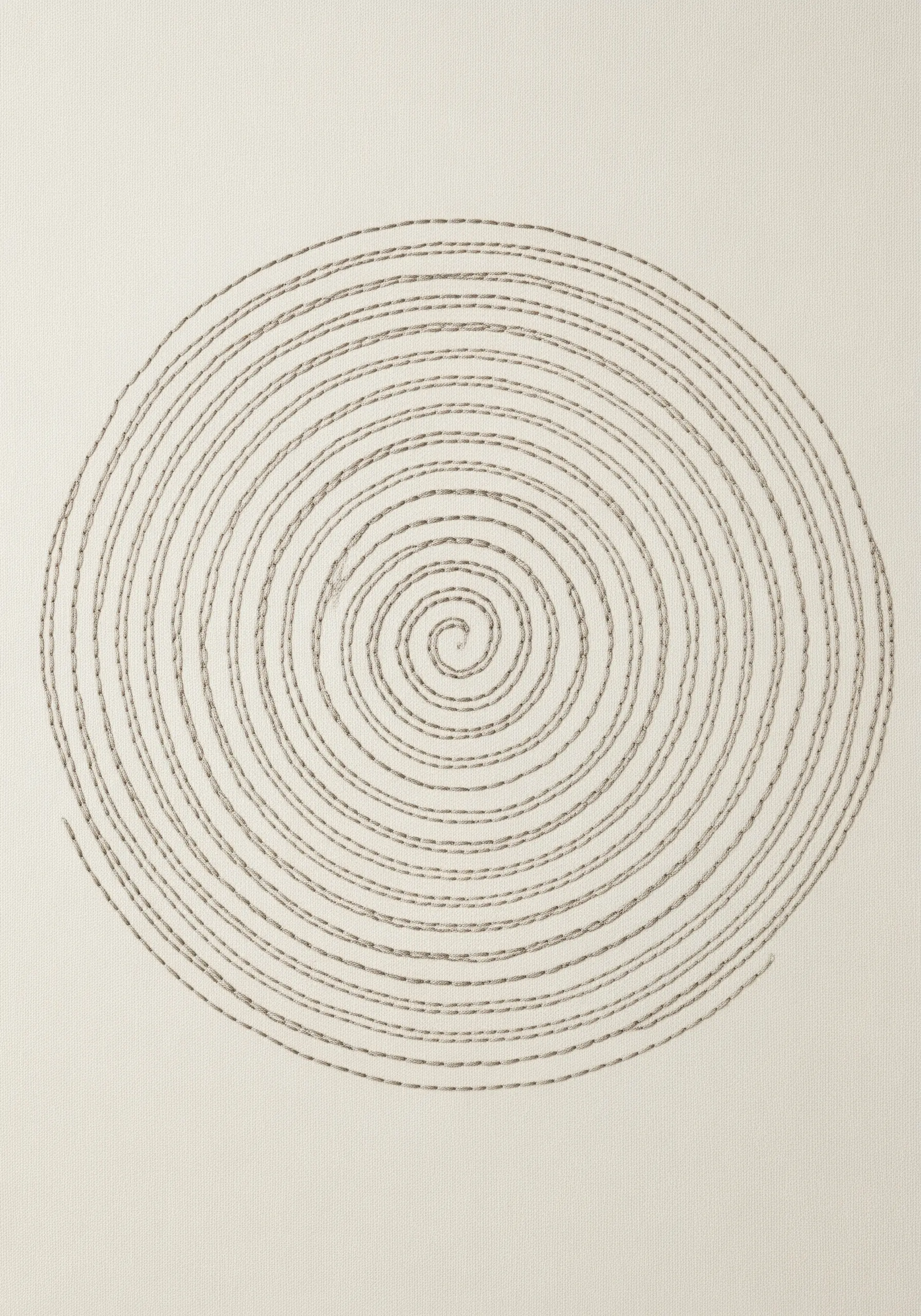 A large, hypnotic spiral created with a simple running stitch on beige fabric.