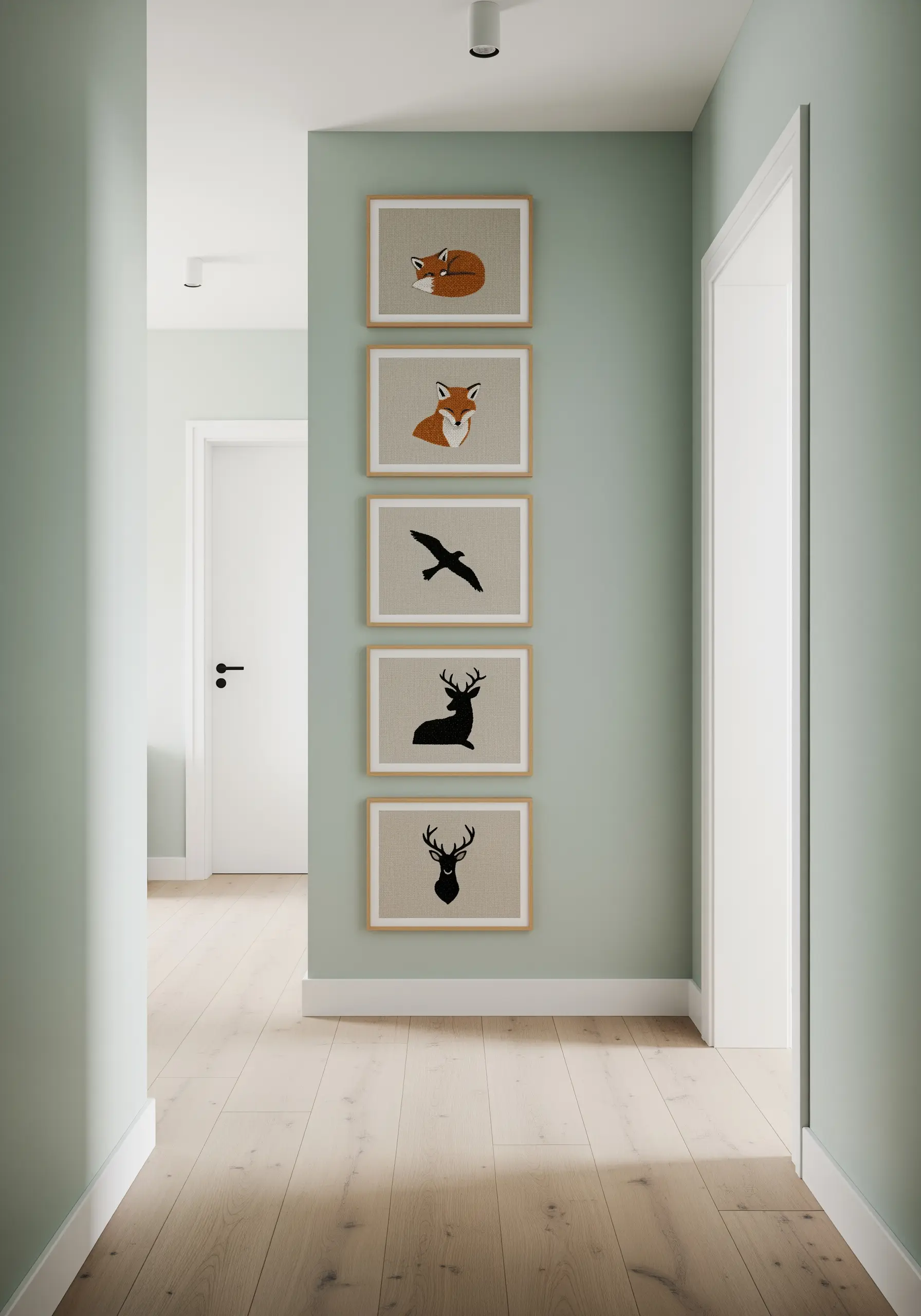A vertical series of five framed embroideries featuring animal silhouettes on a sage green wall.