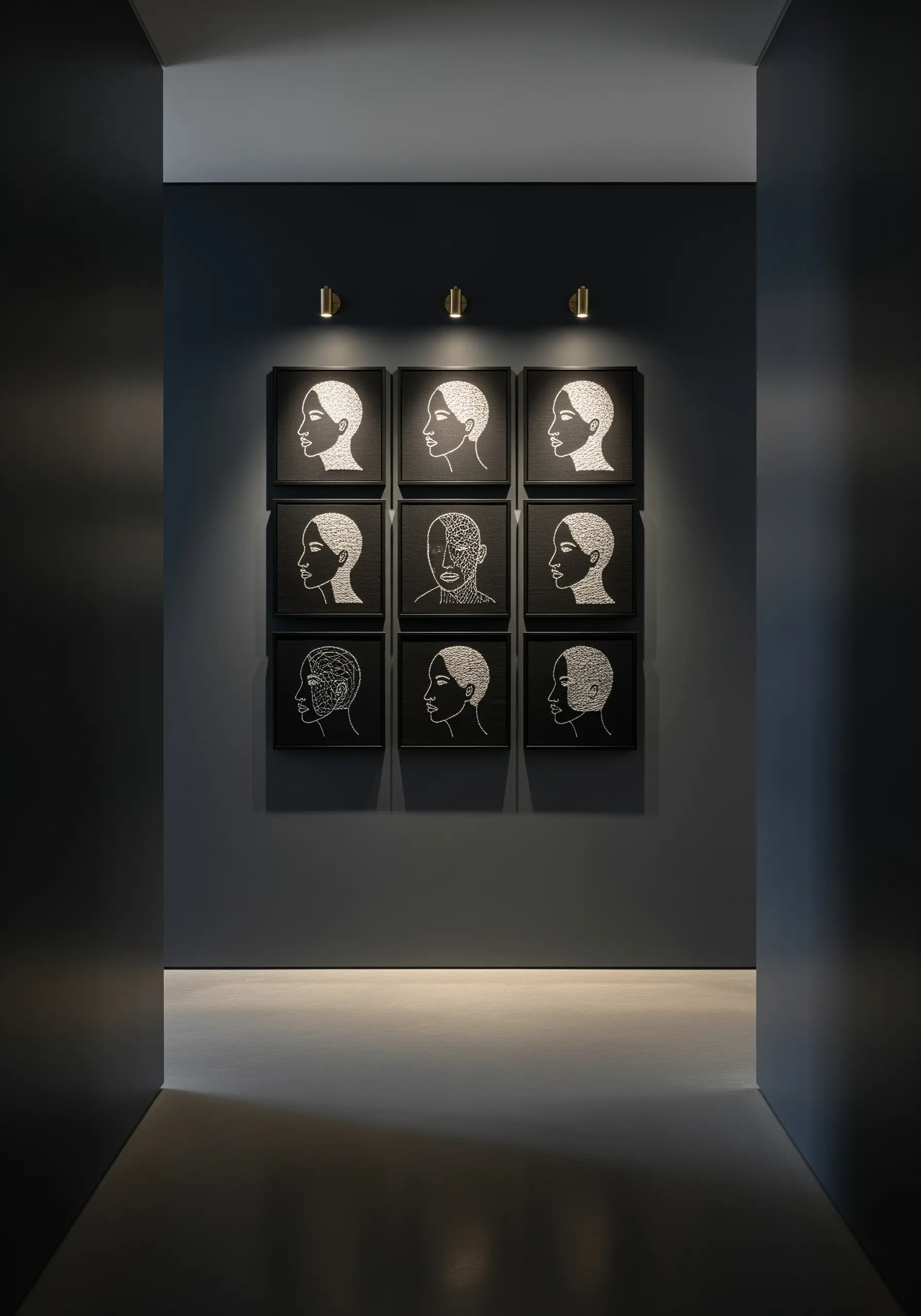A nine-piece grid of embroidered line-art portraits on black fabric in a dark hallway.
