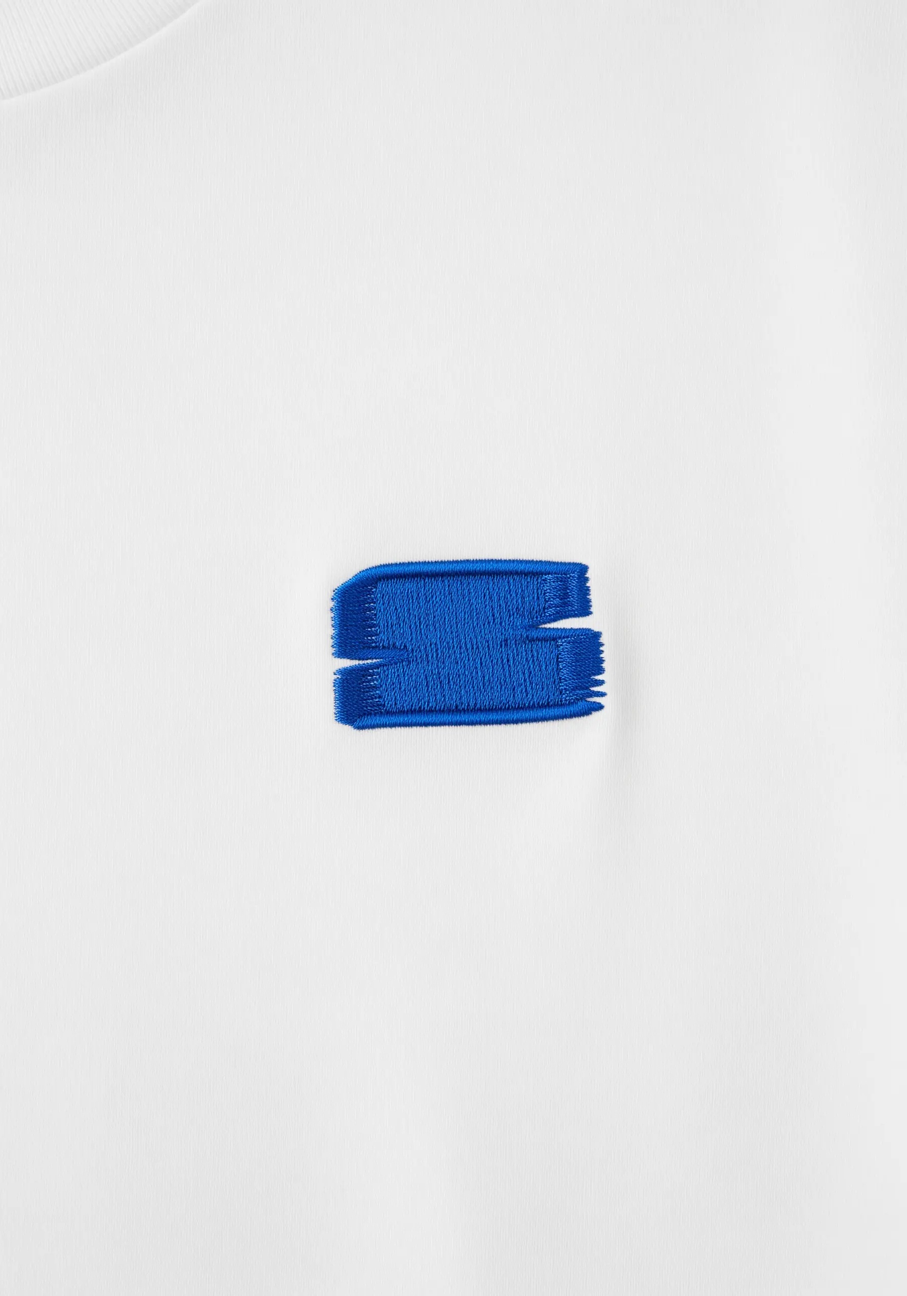 A textured, rectangular brushstroke motif embroidered in bold blue.