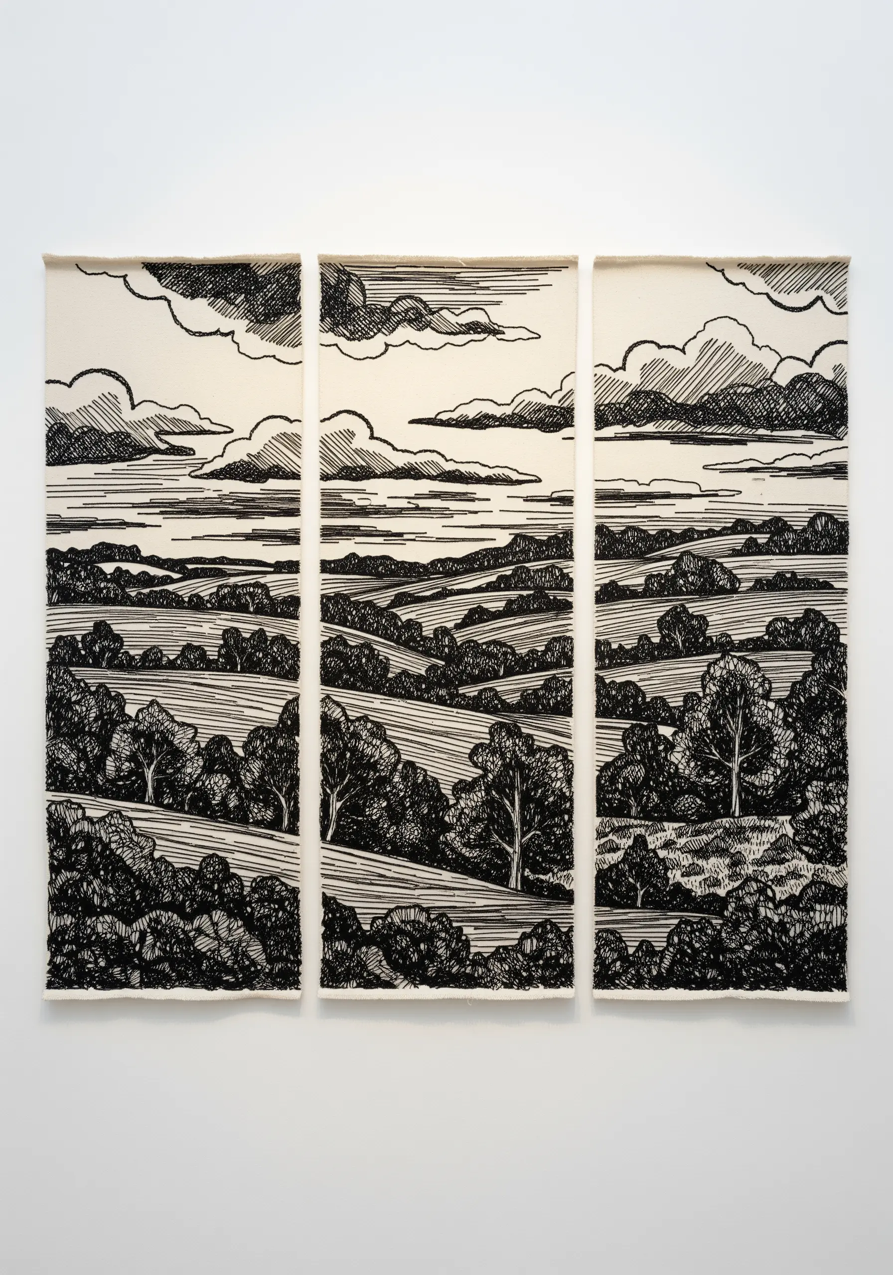 Blackwork landscape embroidery split across three canvas panels