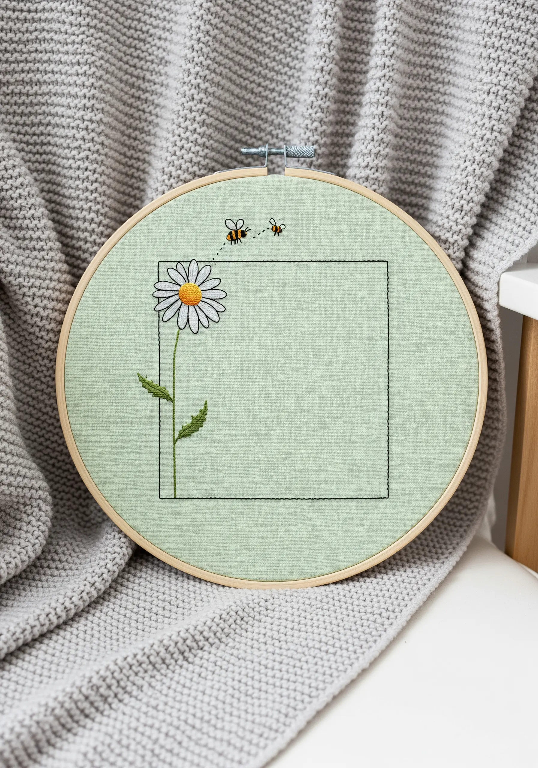 Minimalist embroidery of a single daisy with two bees and a simple square line-art frame.