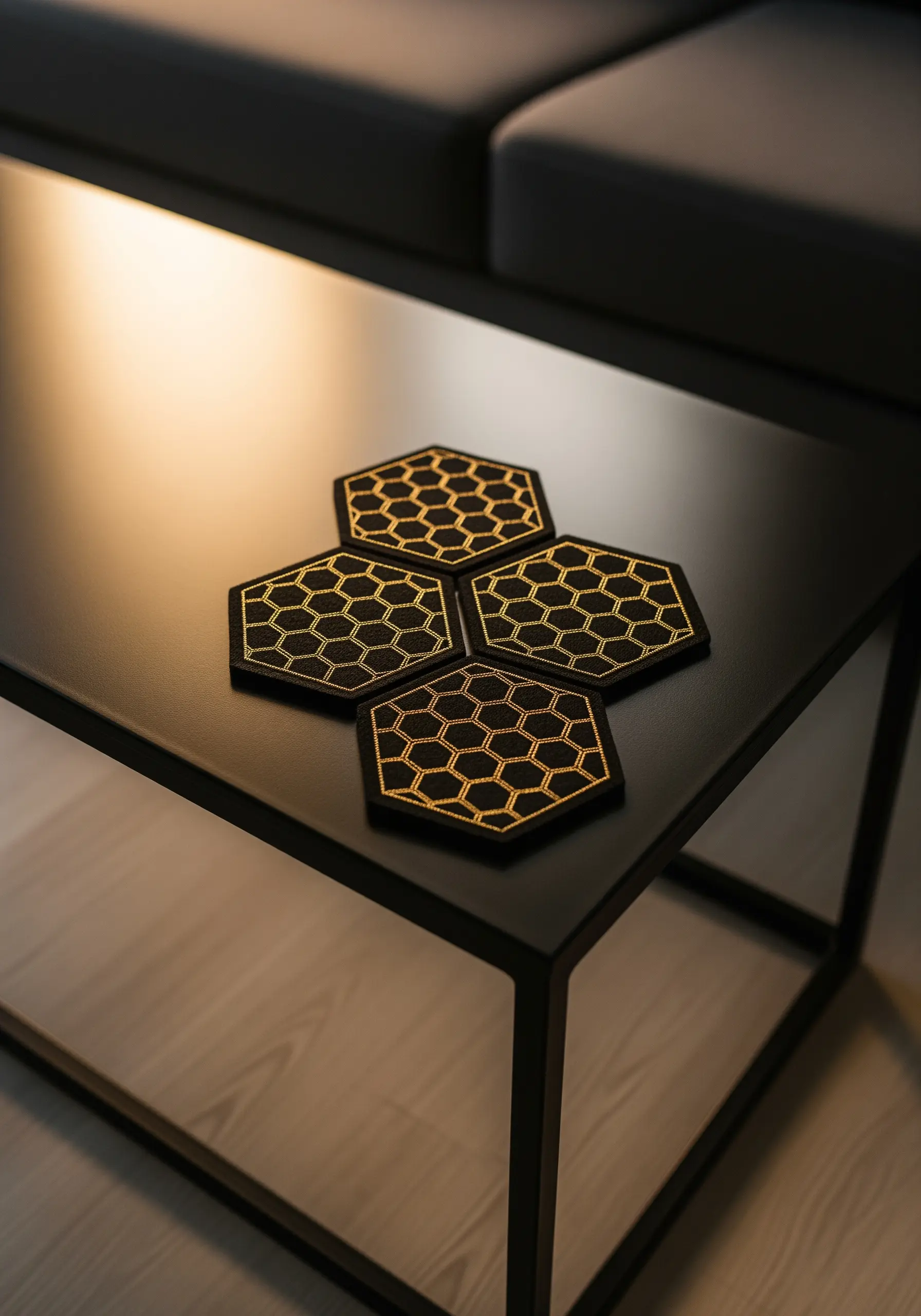 Black hexagonal coasters with a gold metallic thread honeycomb pattern.