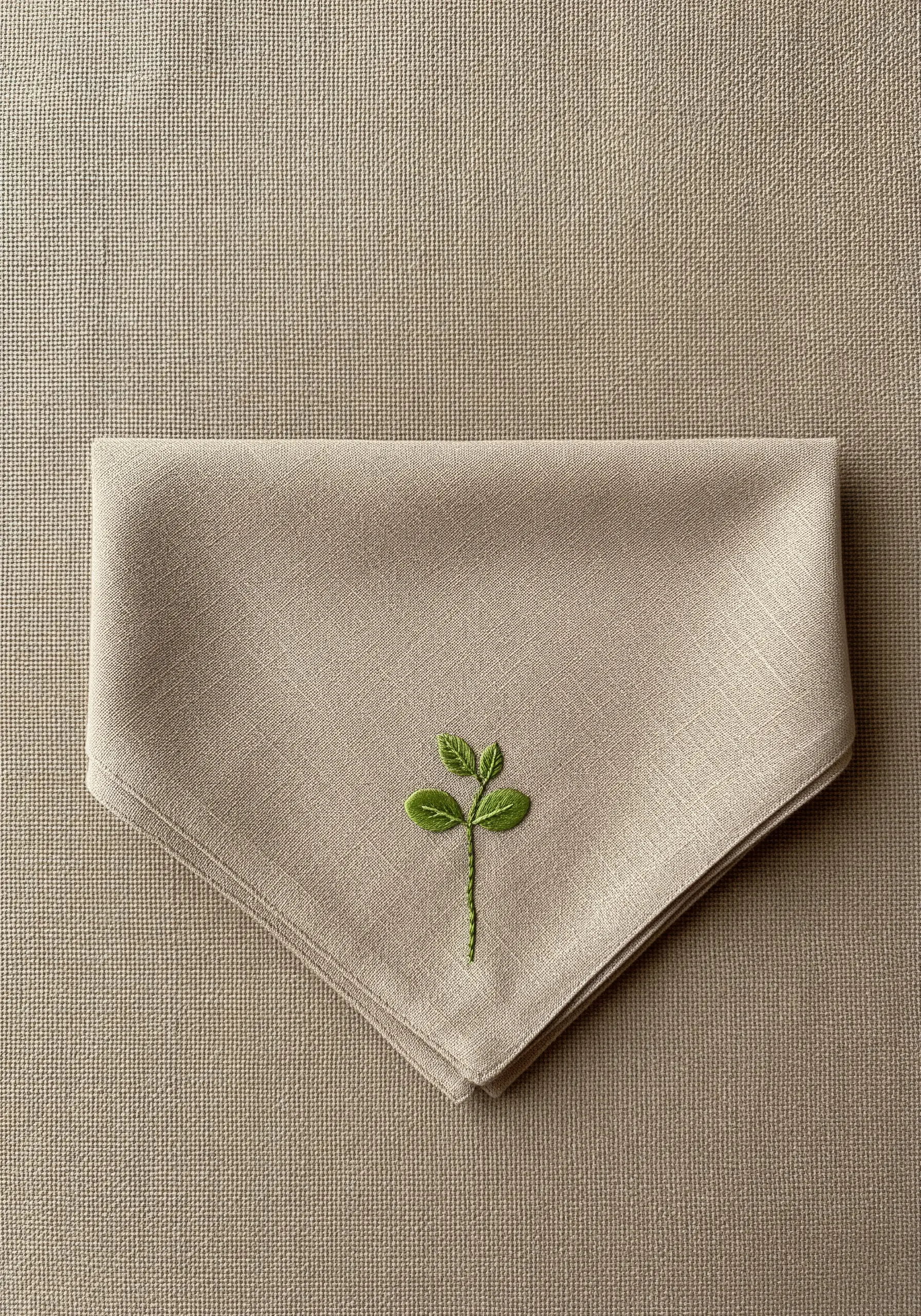 A three-leaf clover embroidered with subtle green color gradients.