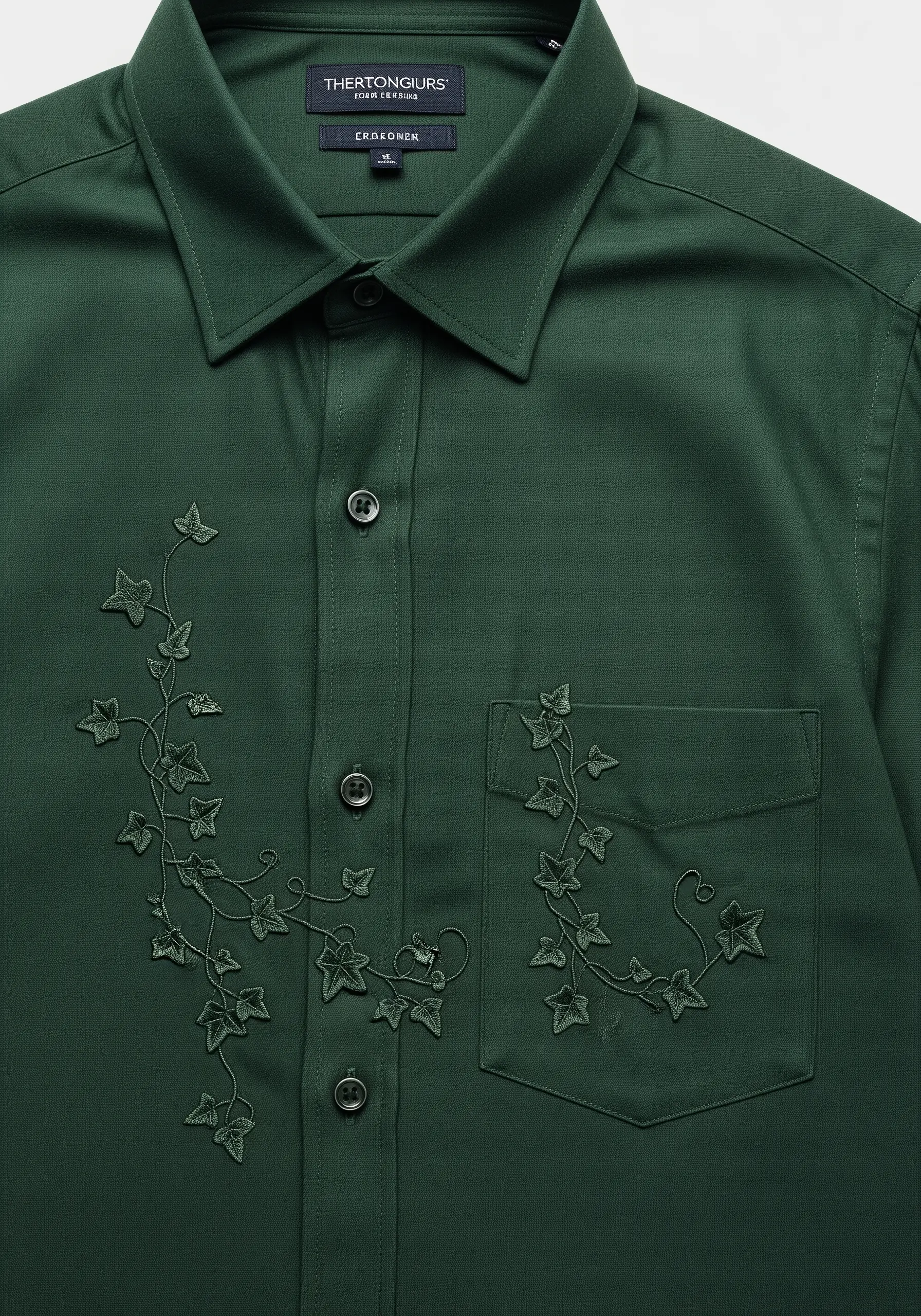 Subtle, tone-on-tone embroidery of ivy vines on a dark green shirt.