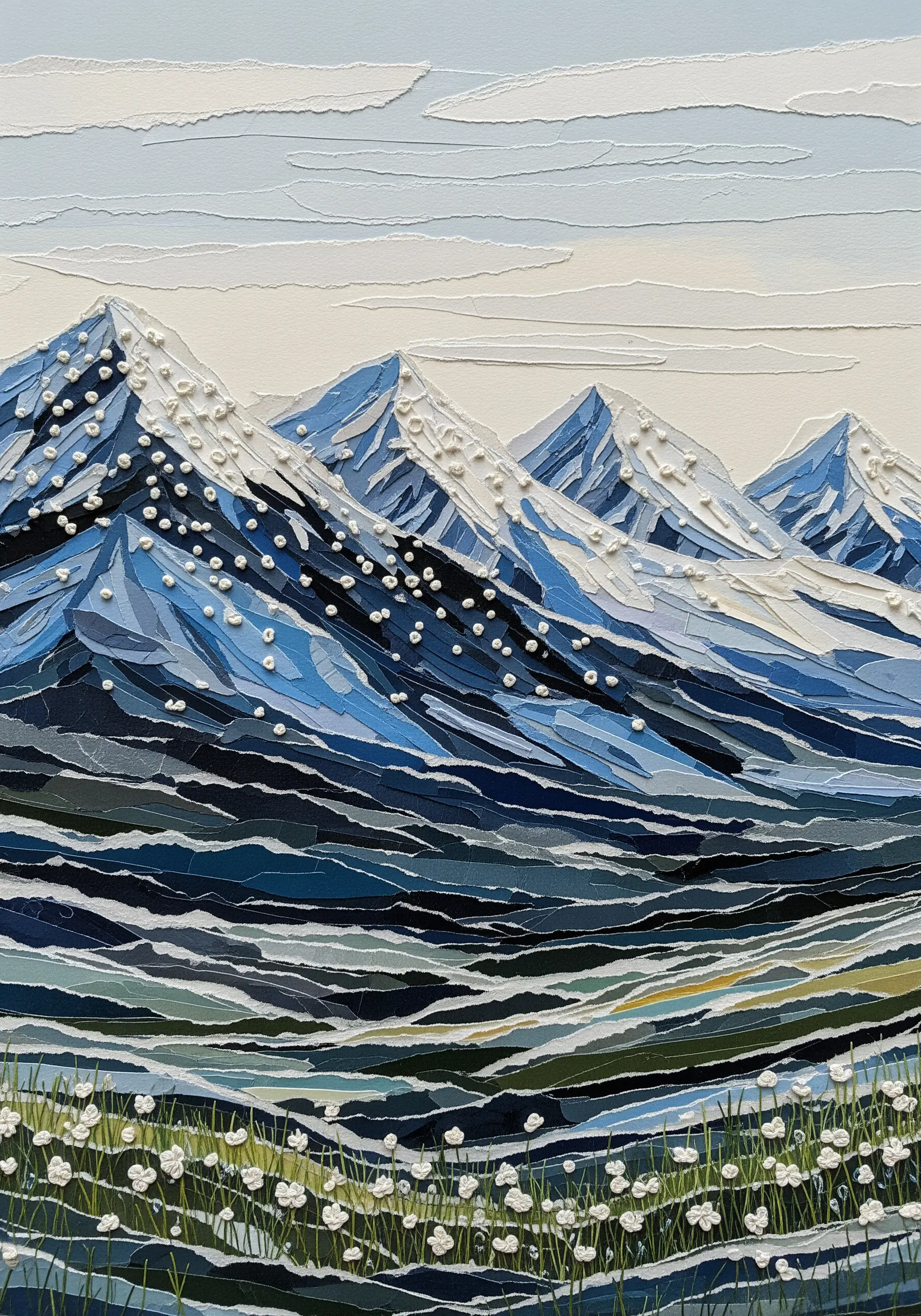 A mountain landscape made from torn blue and white paper, with white French knots for snow.