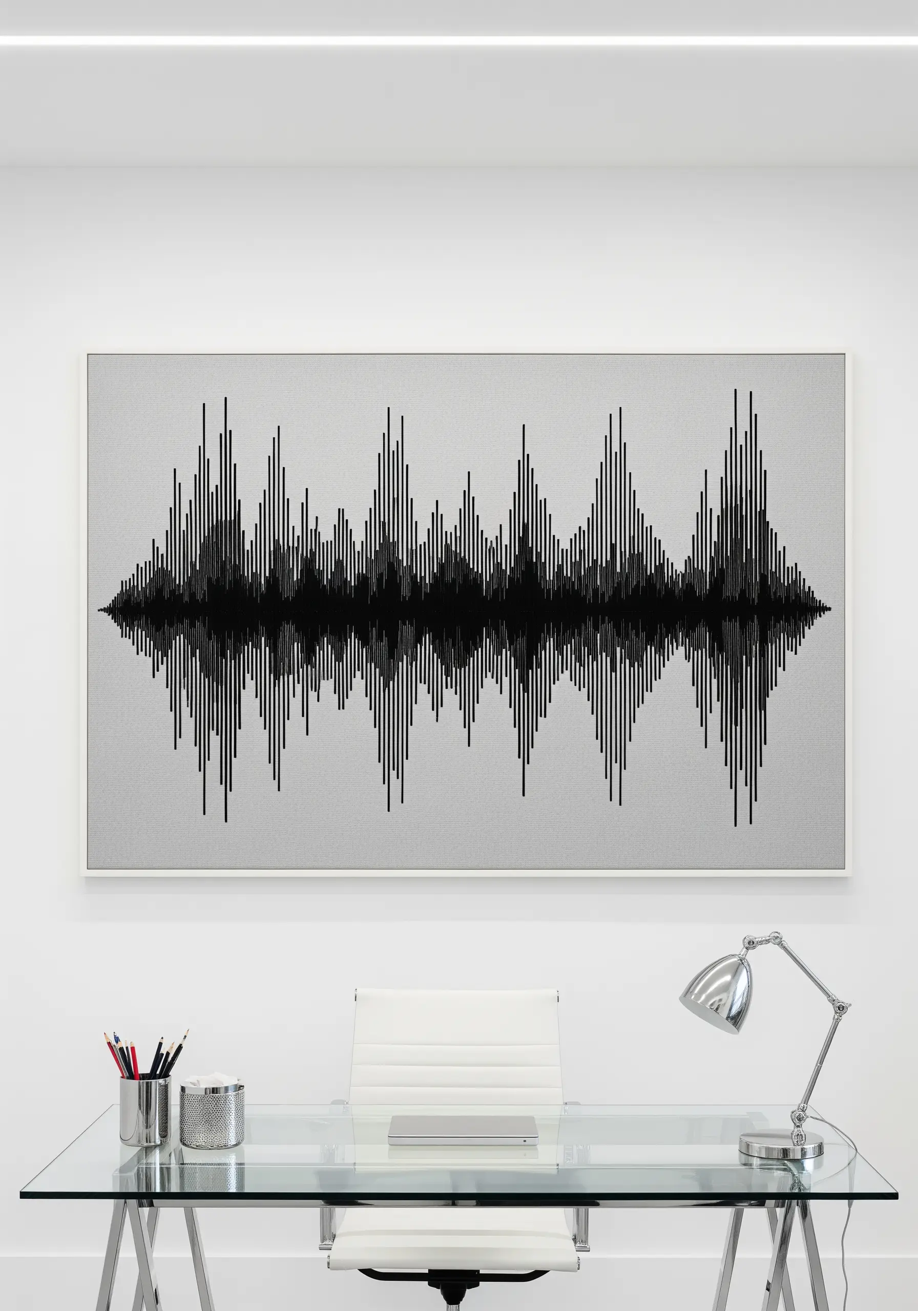 Framed embroidery of a black soundwave pattern on a light gray fabric.