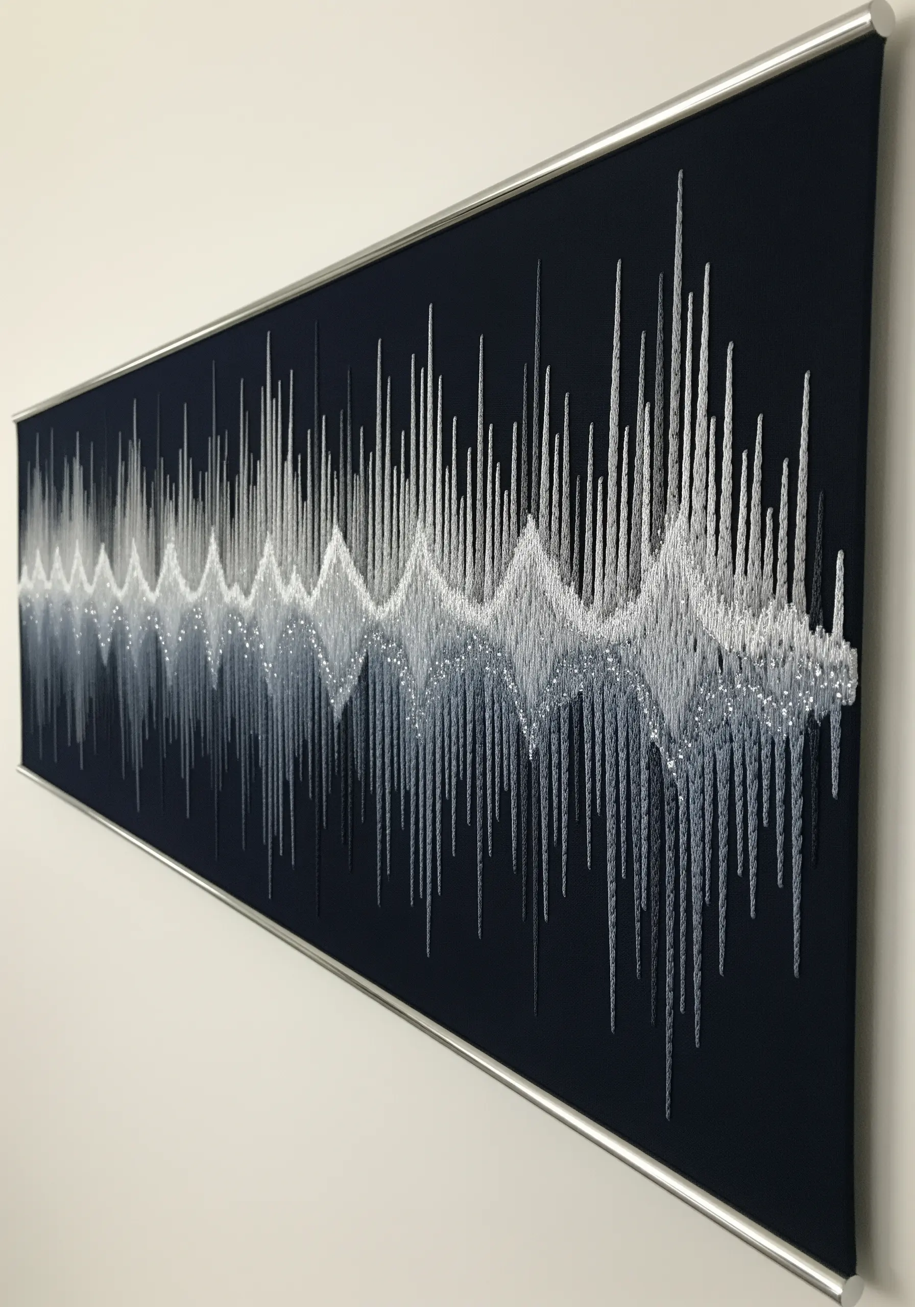A long, rectangular piece of string art depicting a white and grey soundwave on a dark background.