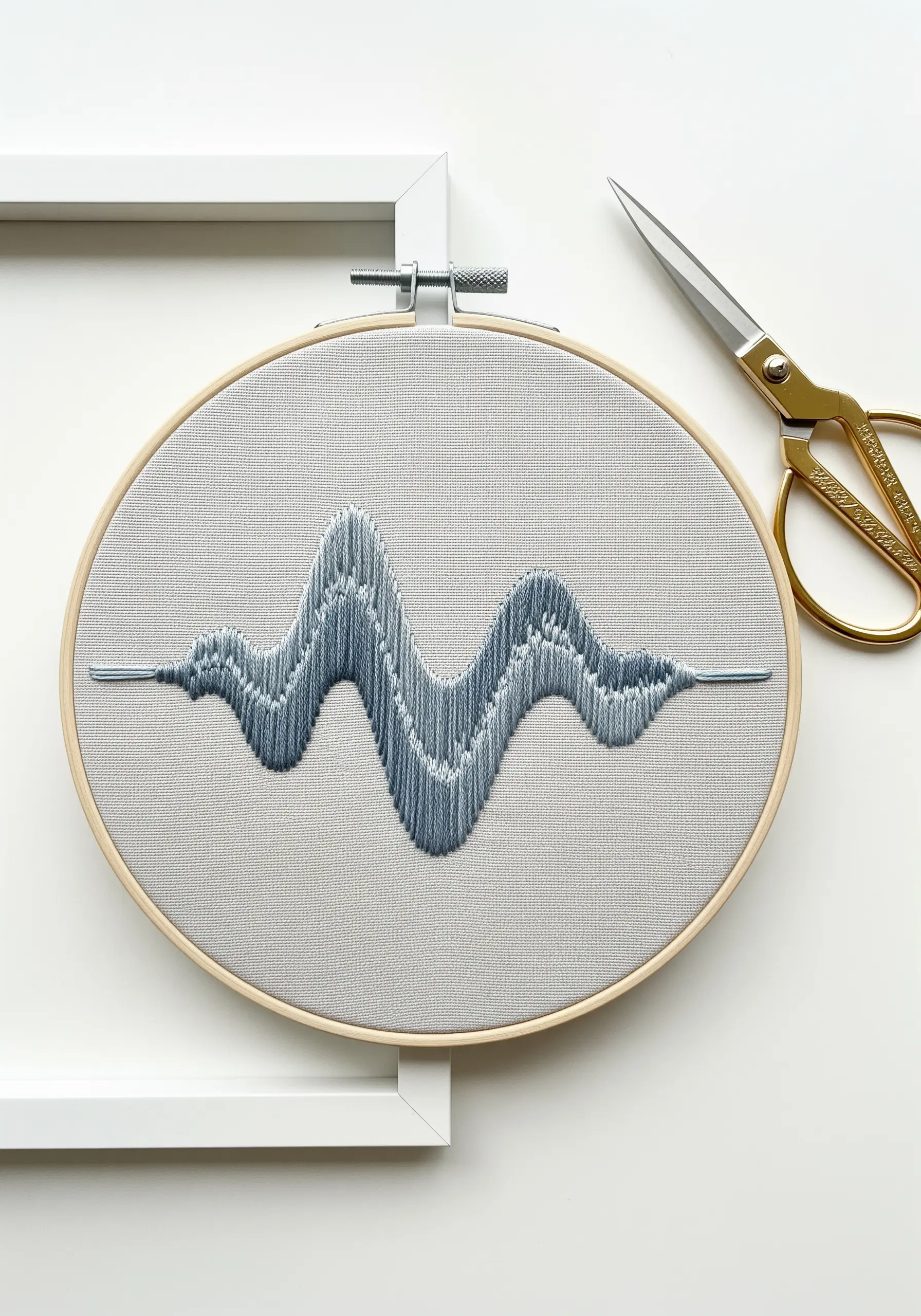 An abstract soundwave pattern embroidered with vertical satin stitches in blue-gray.
