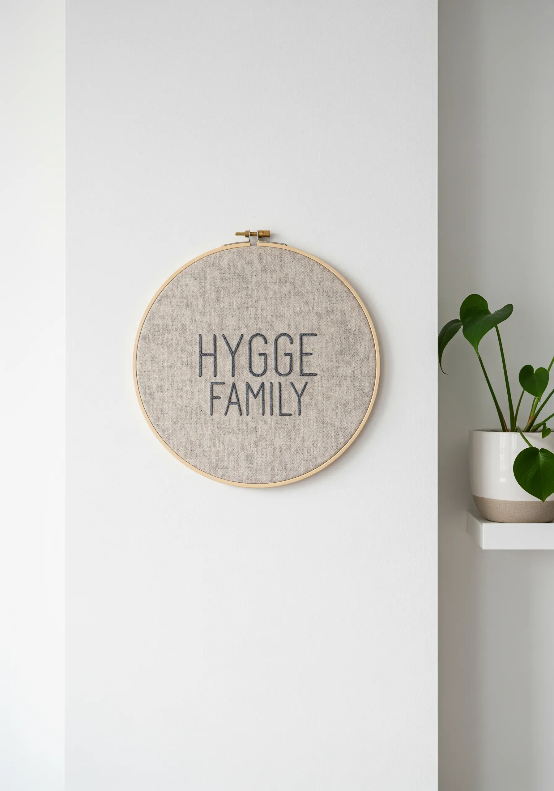 A minimalist embroidery hoop with the words 'Hygge Family' in a simple font.