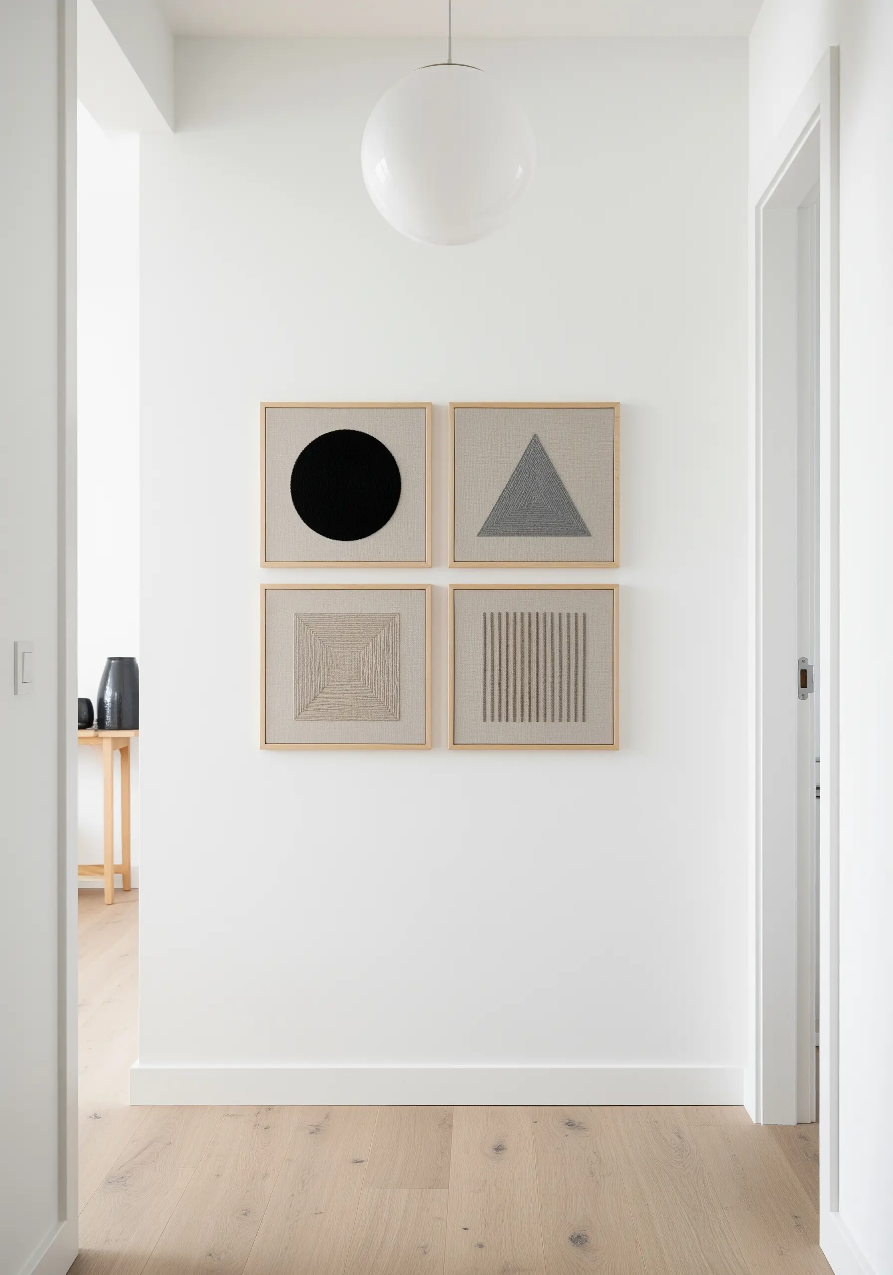 Four framed embroidery pieces with geometric shapes filled with different textural stitches.