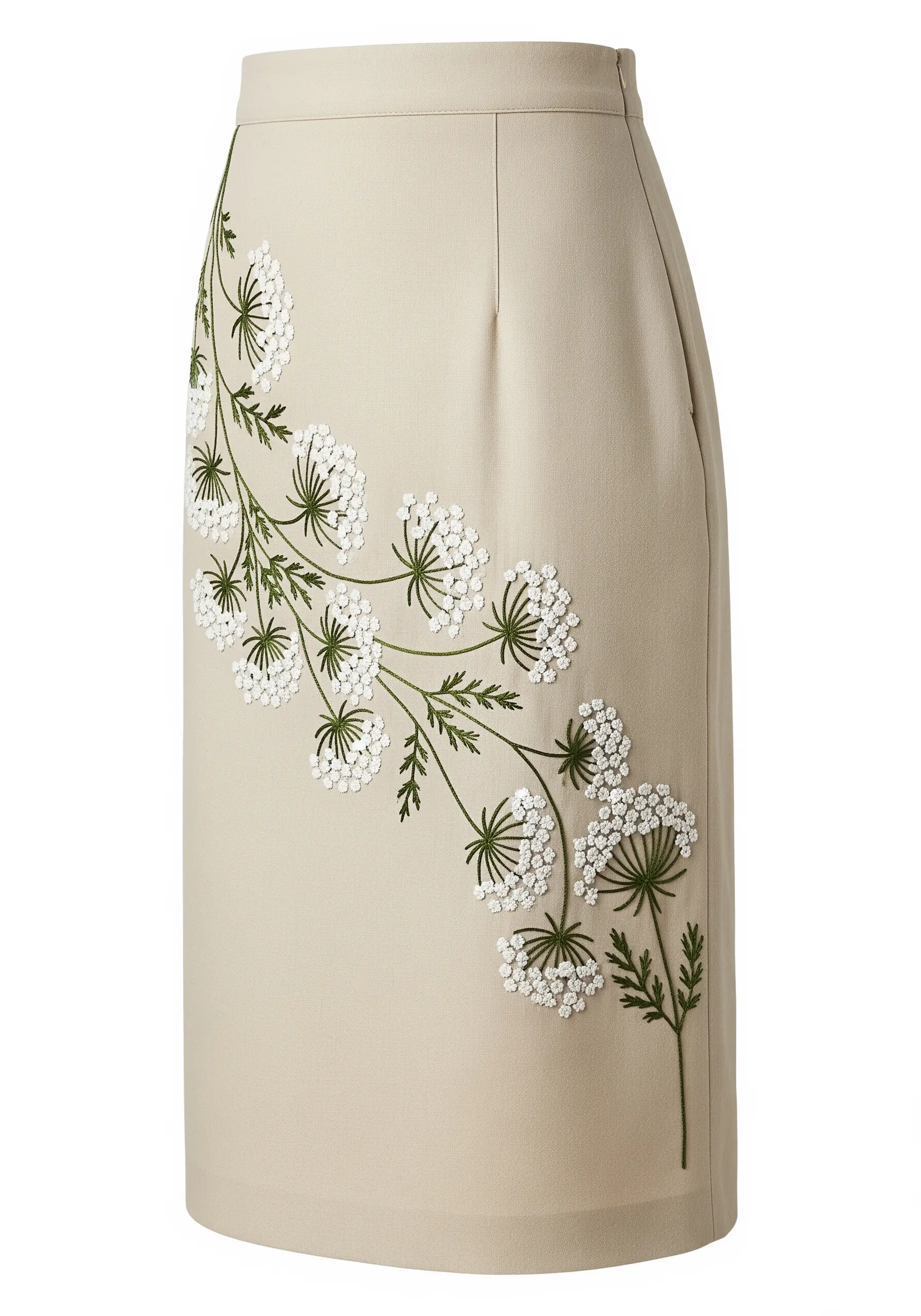 Delicate Queen Anne's lace embroidery climbing up the side of a beige pencil skirt.