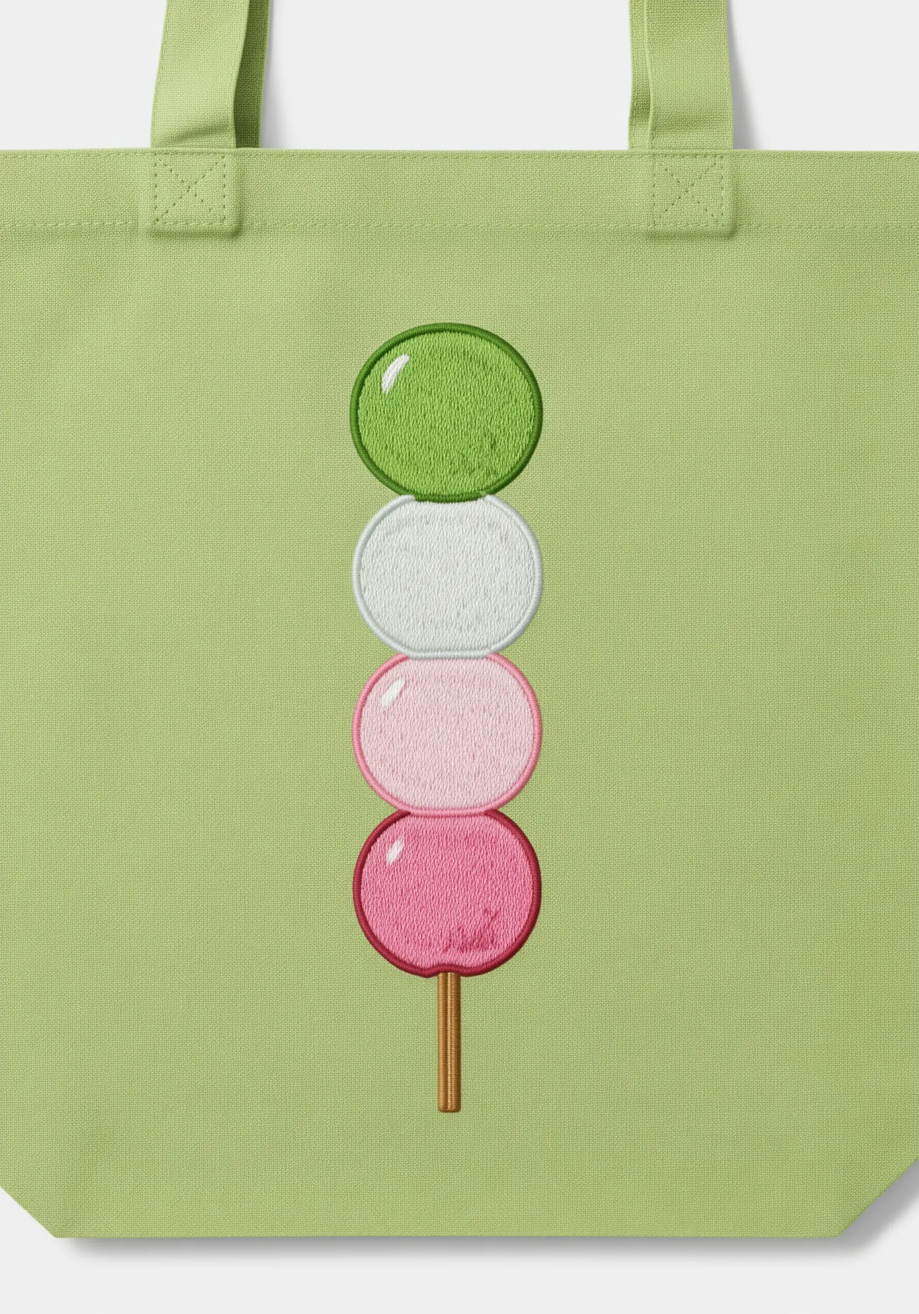 A minimalist embroidery of Japanese dango with a raised, padded satin stitch.