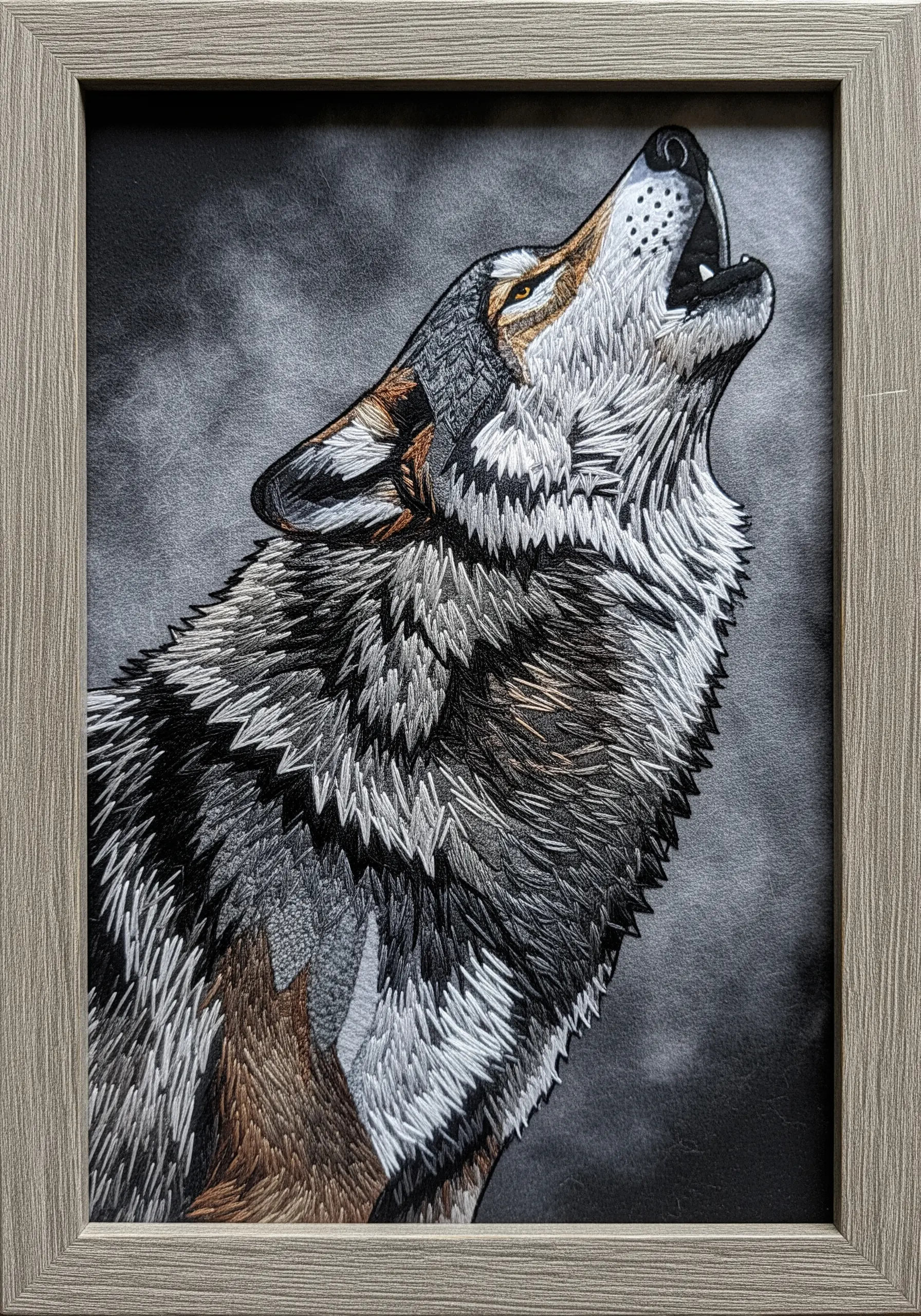 A howling wolf portrait with highly textured fur created by varying stitch length and direction.