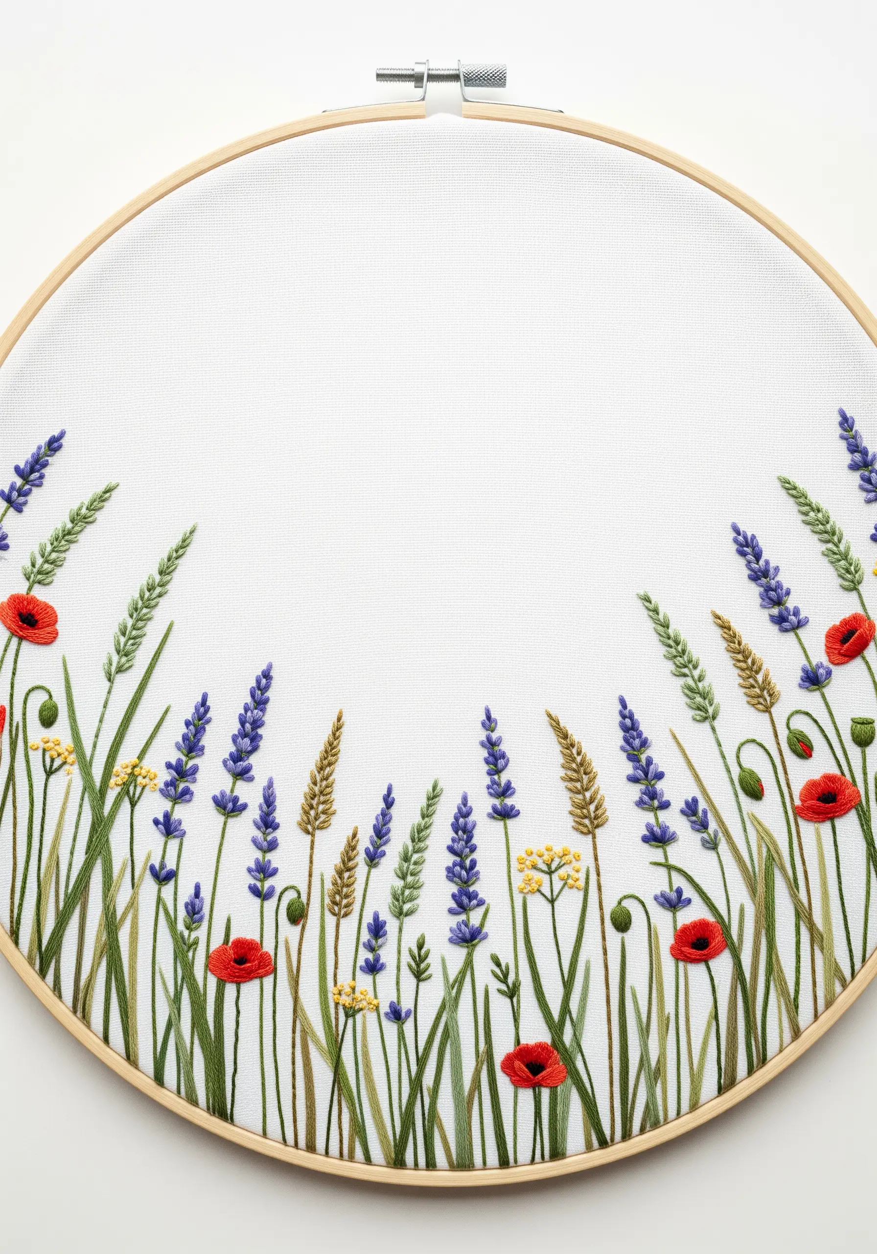 Border of embroidered wildflowers and grasses at the bottom of a hoop