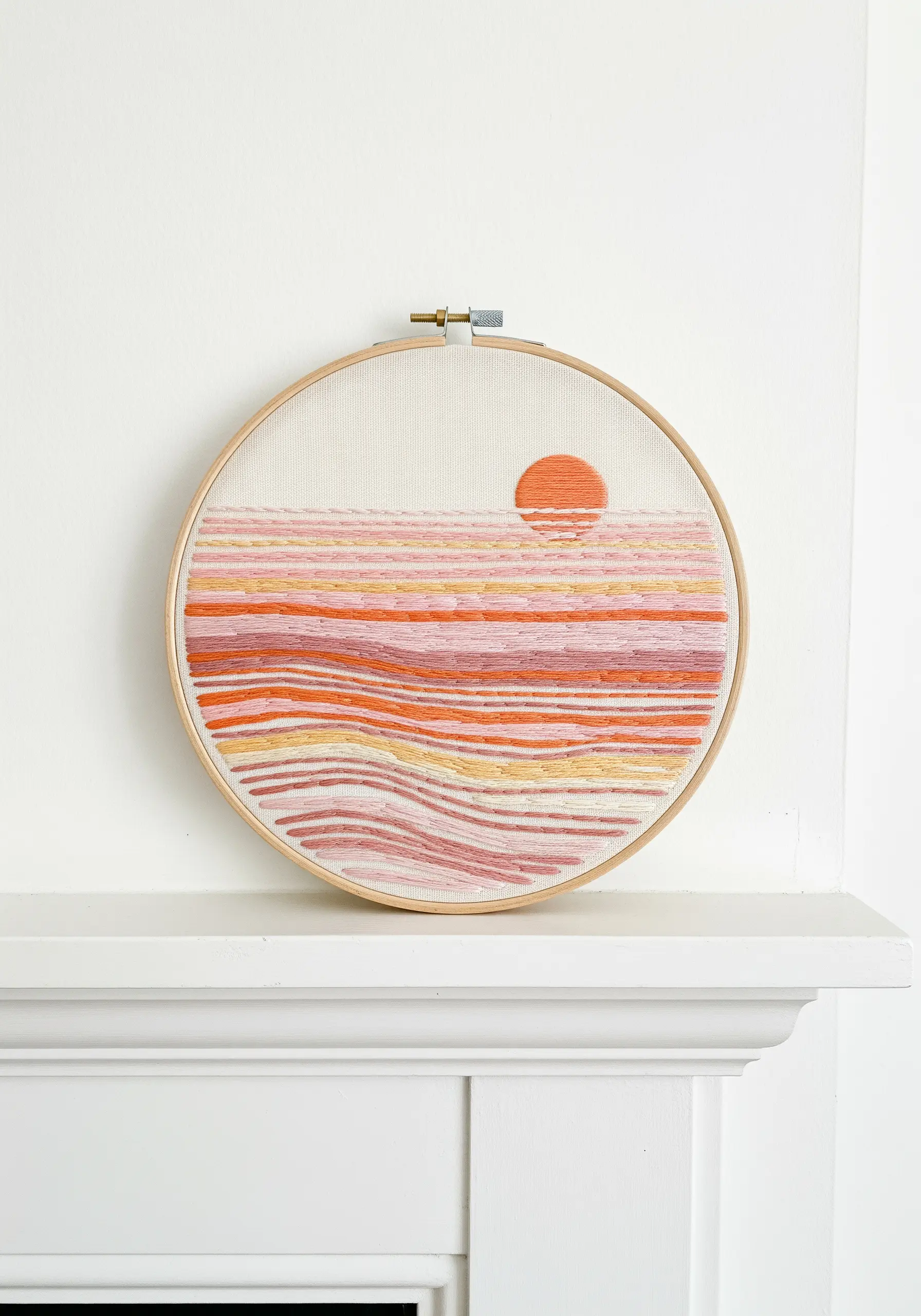 Abstract sunset embroidery with horizontal stitches in pink, orange, and yellow.