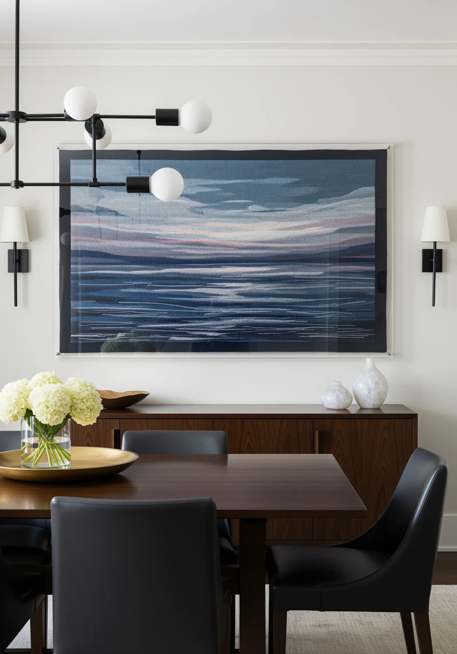 Abstract embroidered seascape with layered horizontal stitches in blues and pinks.