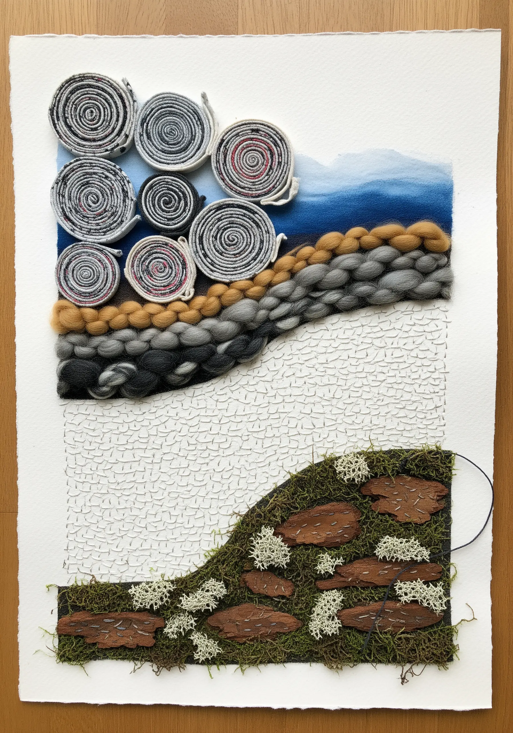 Mixed-media collage on paper with weaving, rolled fabric, moss, and bark elements.