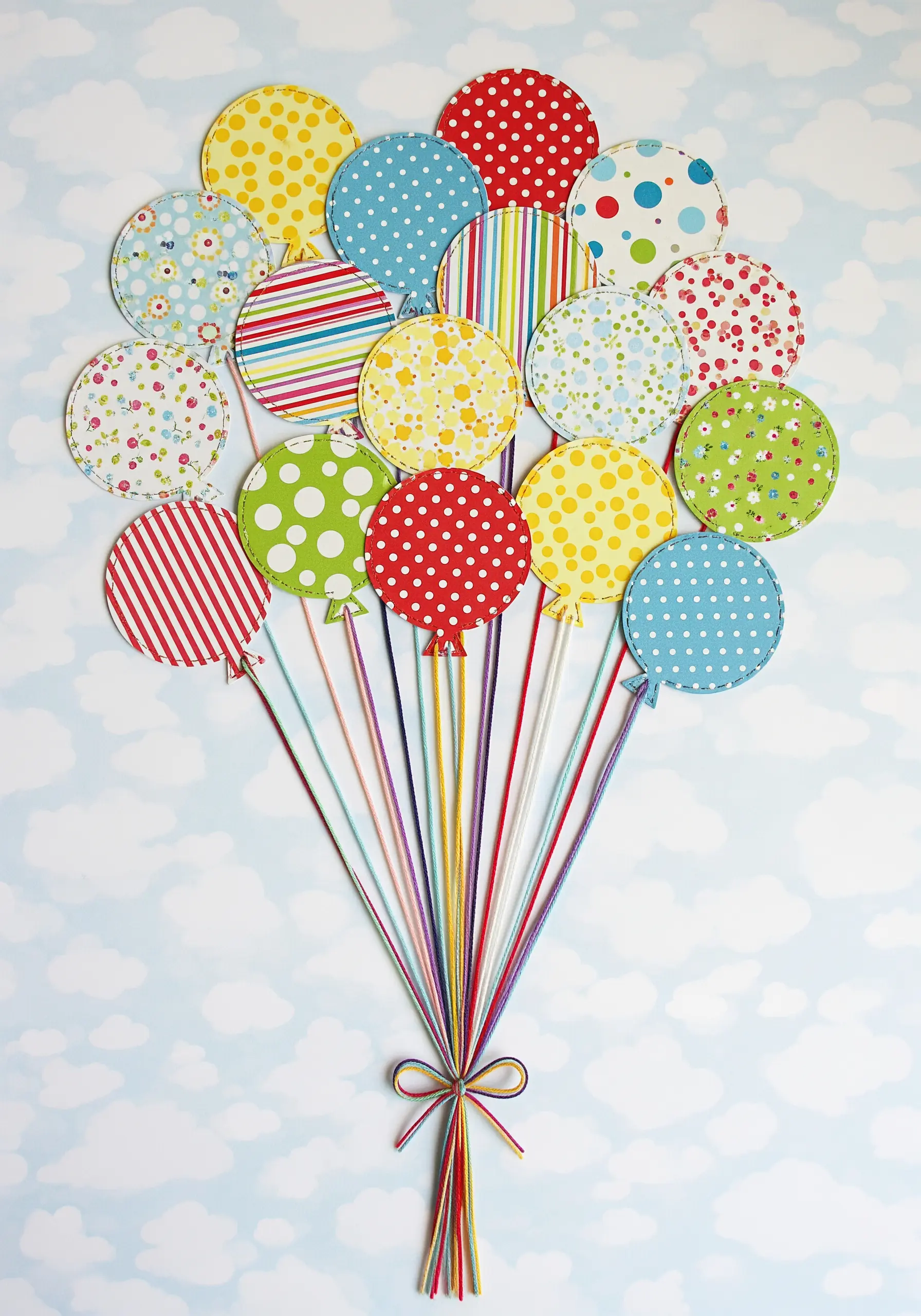 Patterned paper circles as balloons with gathered thread strings