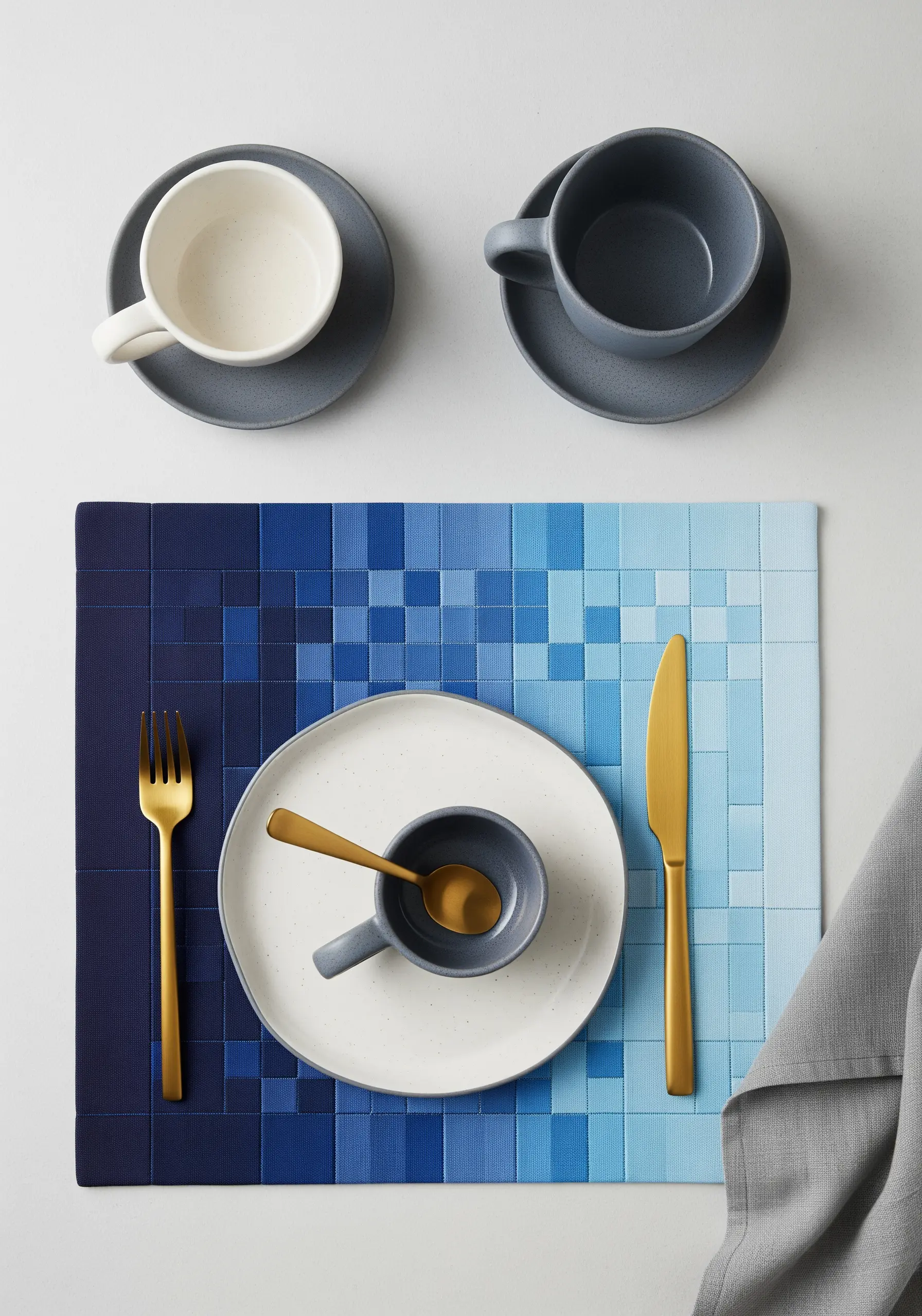 Placemat with a woven, pixelated pattern in a gradient of blue tones