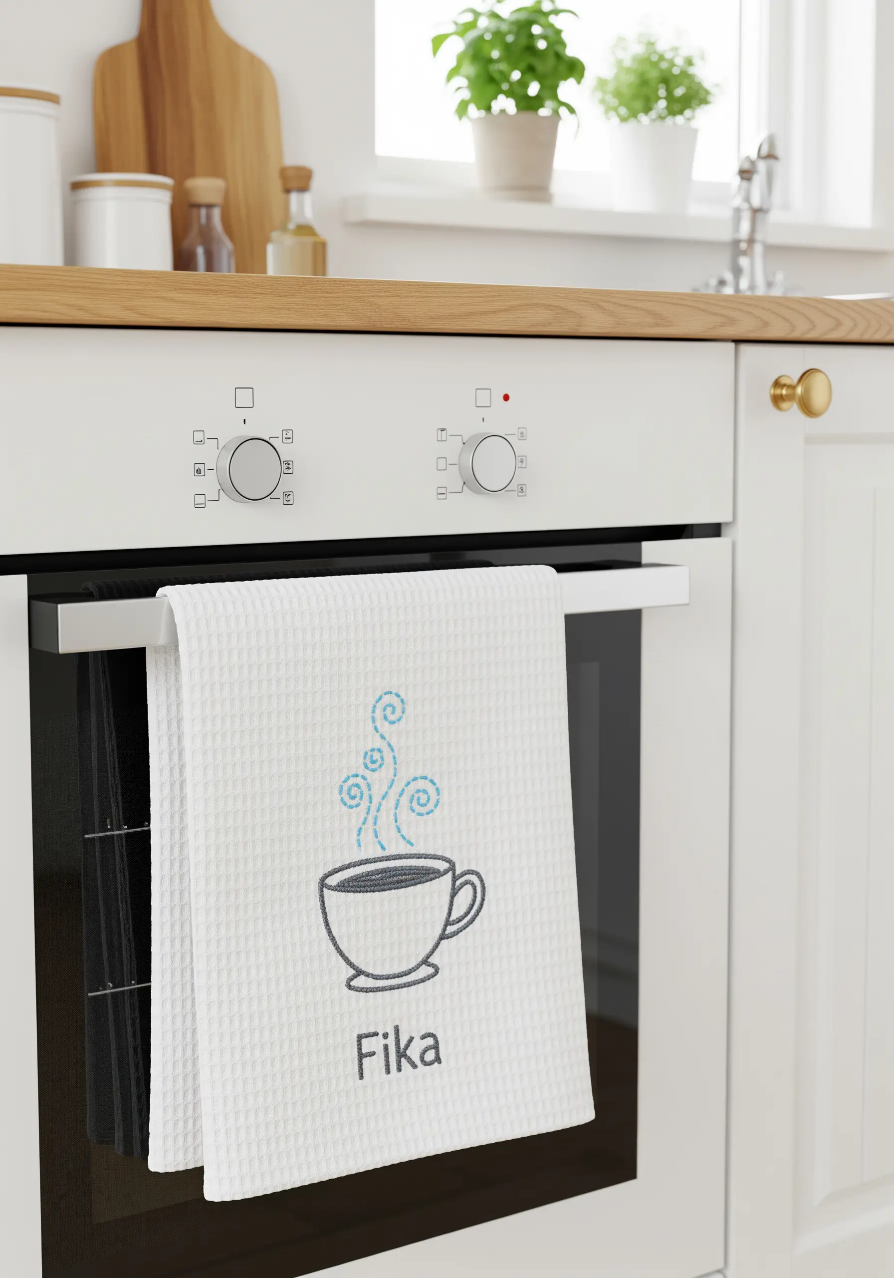 A simple line art coffee cup with 'Fika' text embroidered on a white waffle towel.