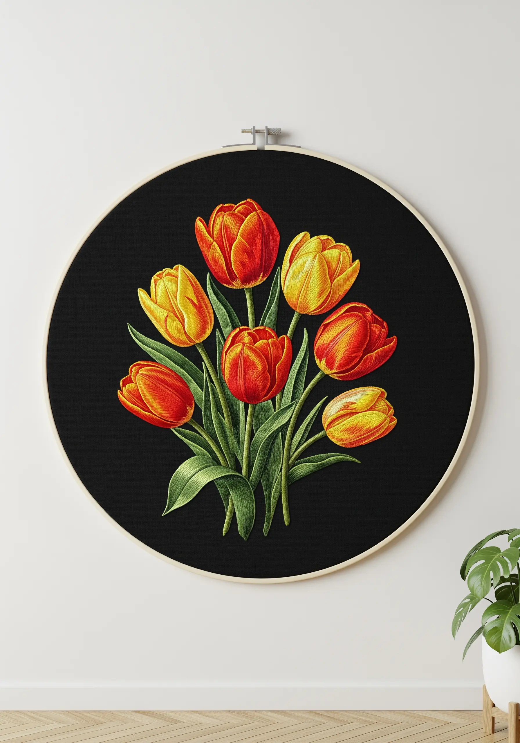 A vibrant bouquet of red and yellow tulips embroidered on a stark black fabric background.