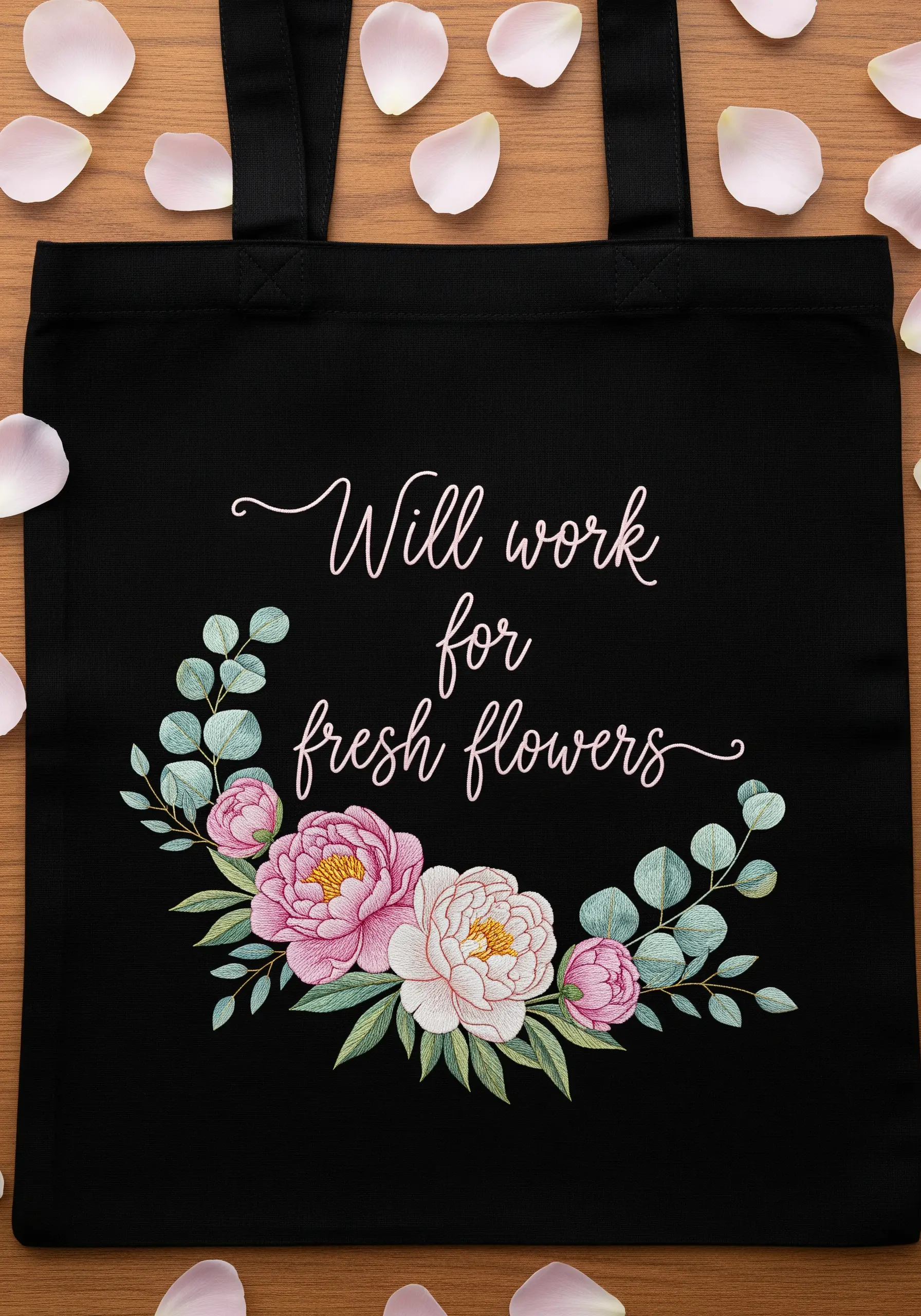 Black tote bag with a lush bouquet of embroidered peonies and a delicate script quote.