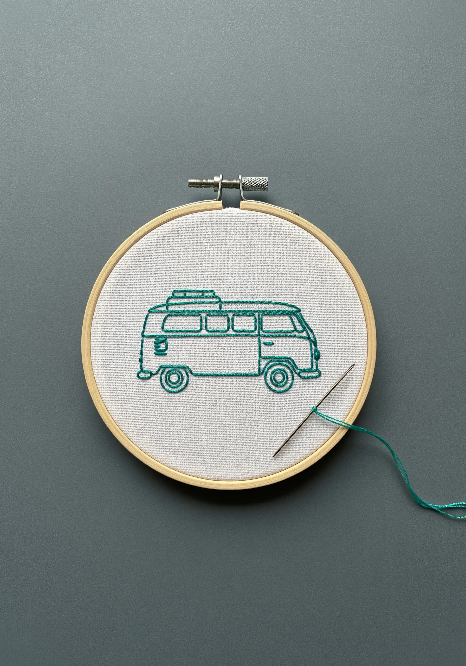 A simple outline embroidery of a vintage camper van.