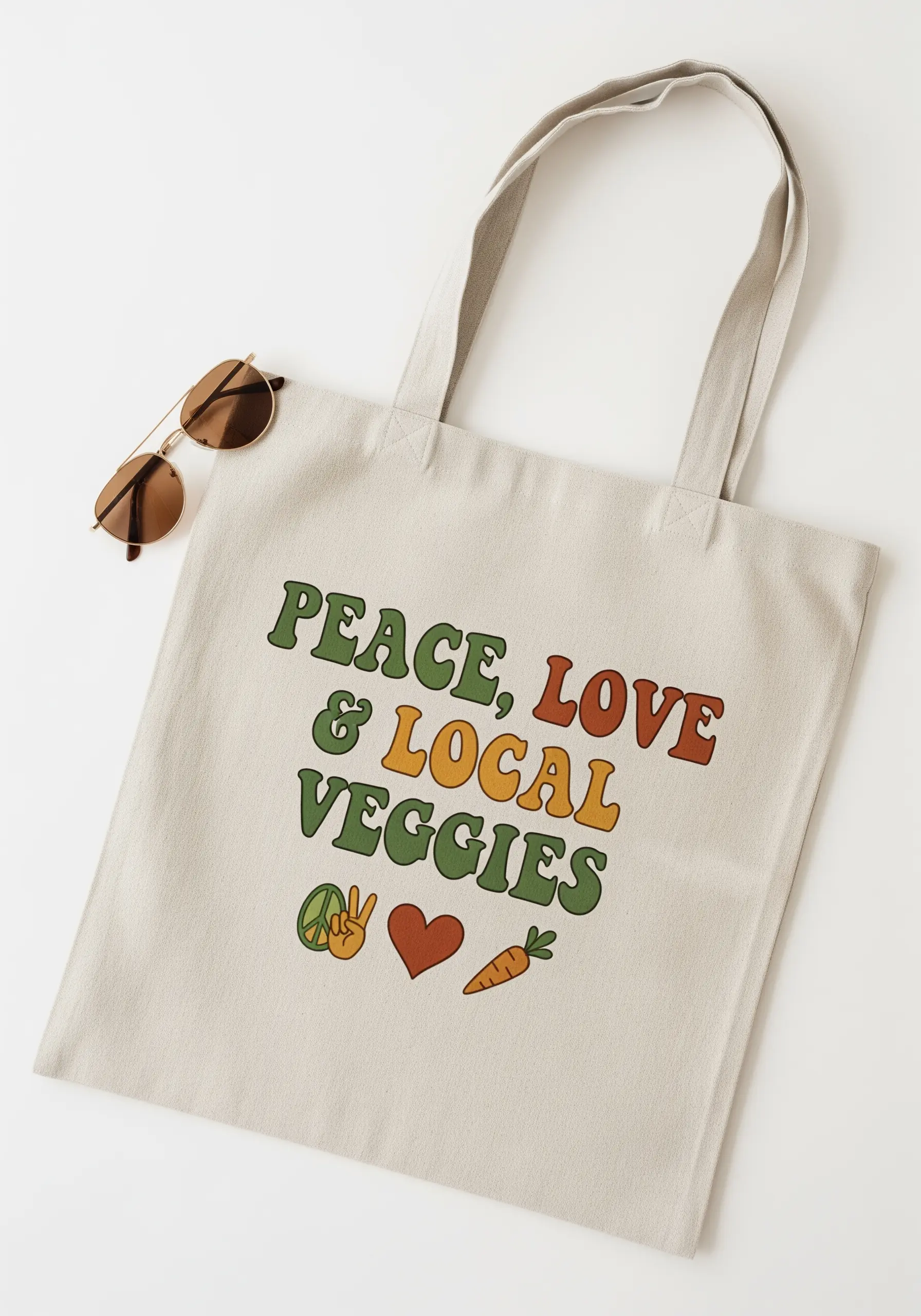Tote bag with a '70s-style retro font reading 'Peace, Love & Local Veggies'.