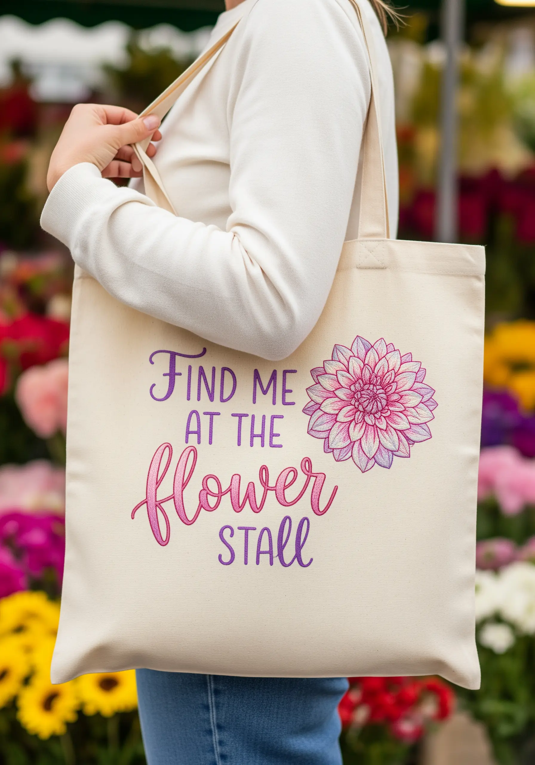 Tote bag with 'Find me at the flower stall' in ombré script and a detailed dahlia.