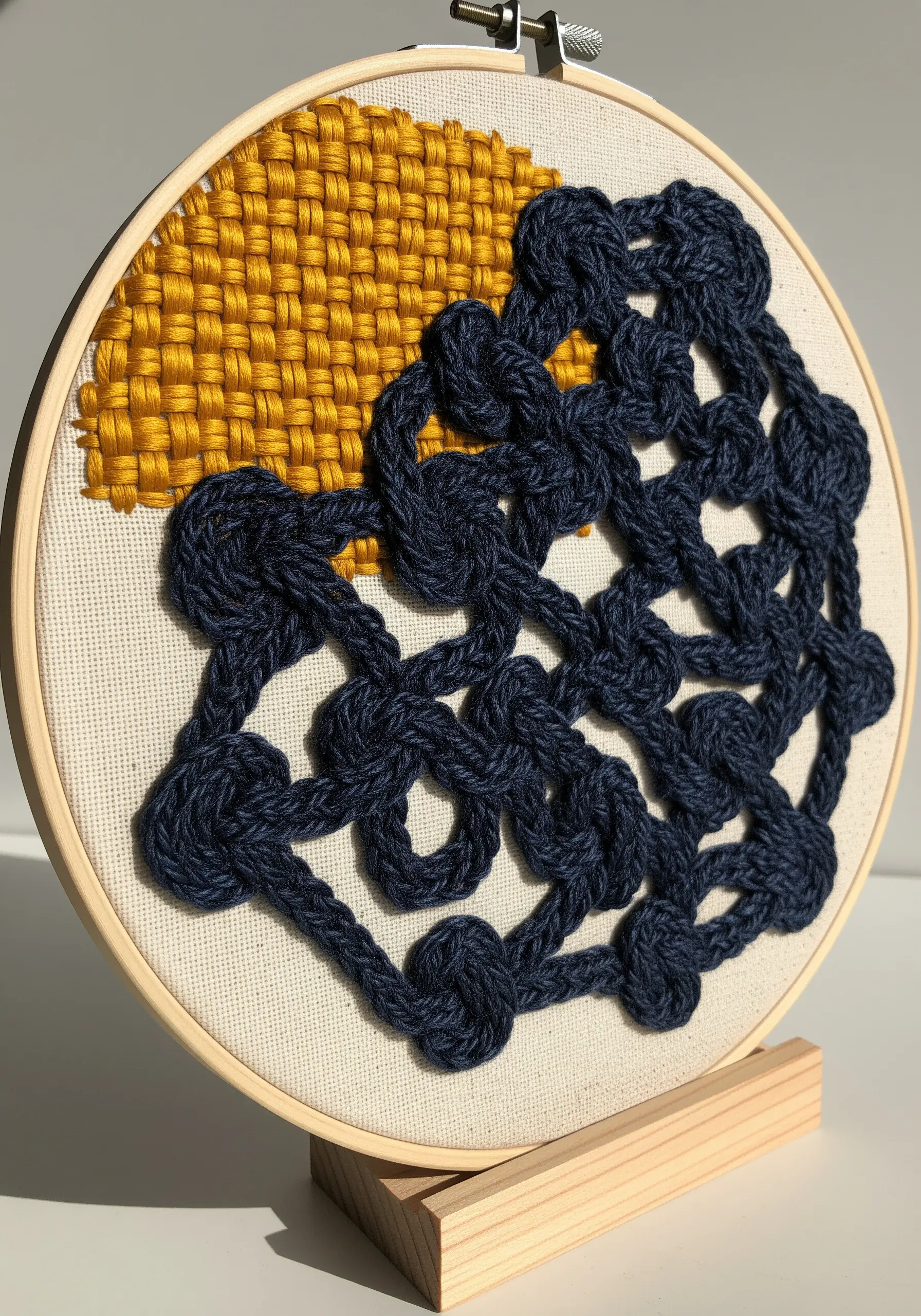 A section of flat woven yellow thread next to a tangled composition of bulky navy blue knots.