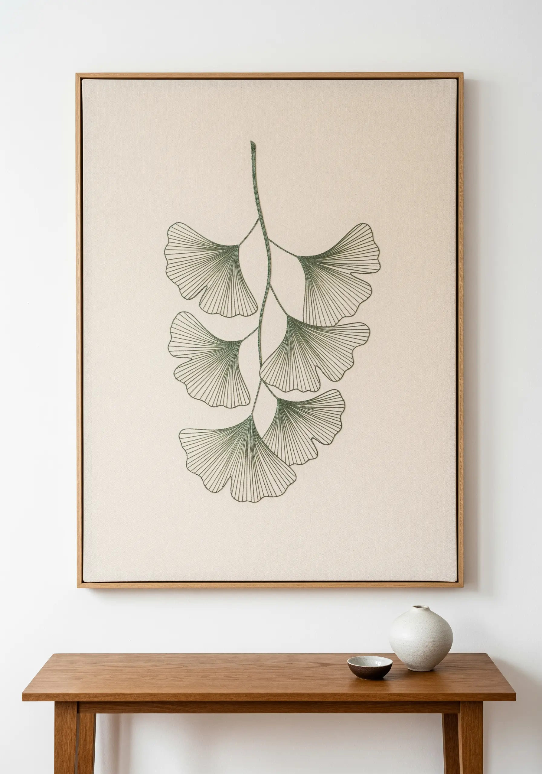 Framed wall art featuring a ginkgo branch with detailed leaf vein stitching.
