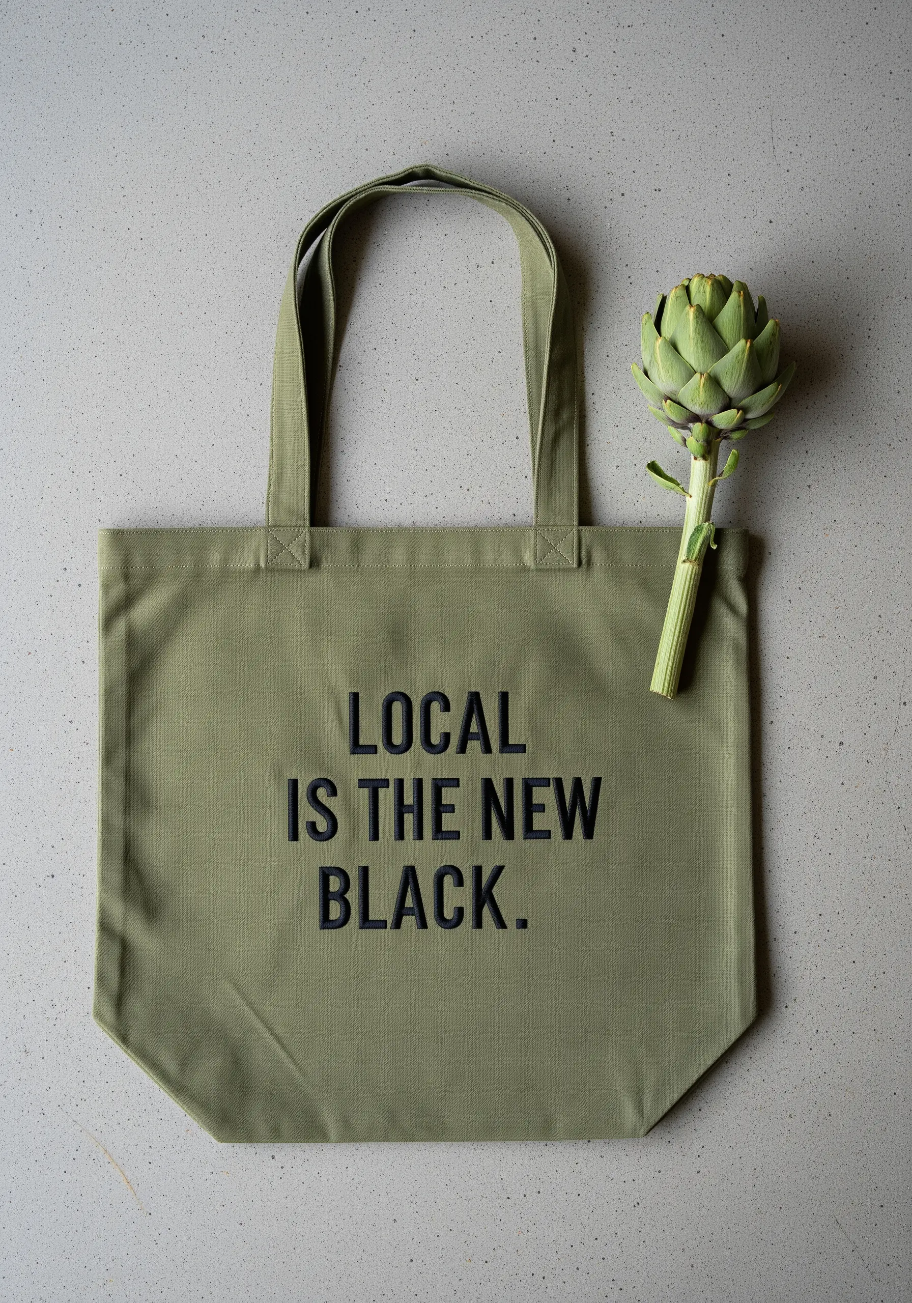 Olive green tote with a modern, sans-serif quote stitched in black thread.