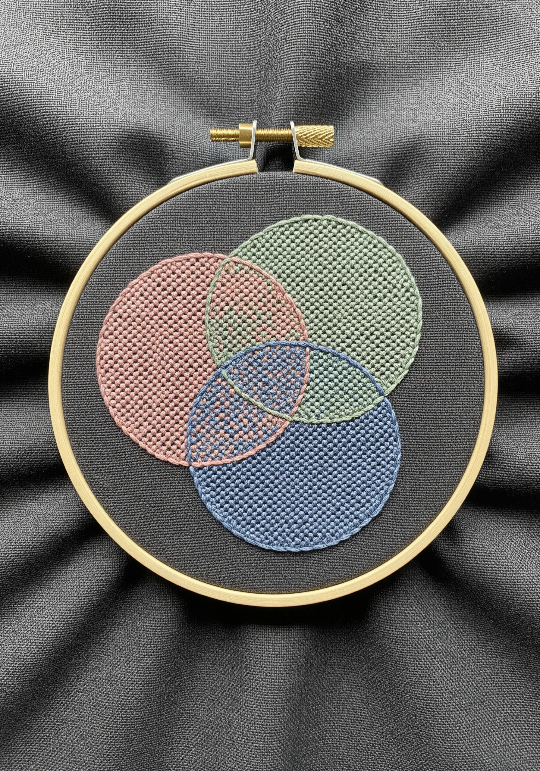 Three overlapping circles in pink, green, and blue, filled with textured seed stitch.