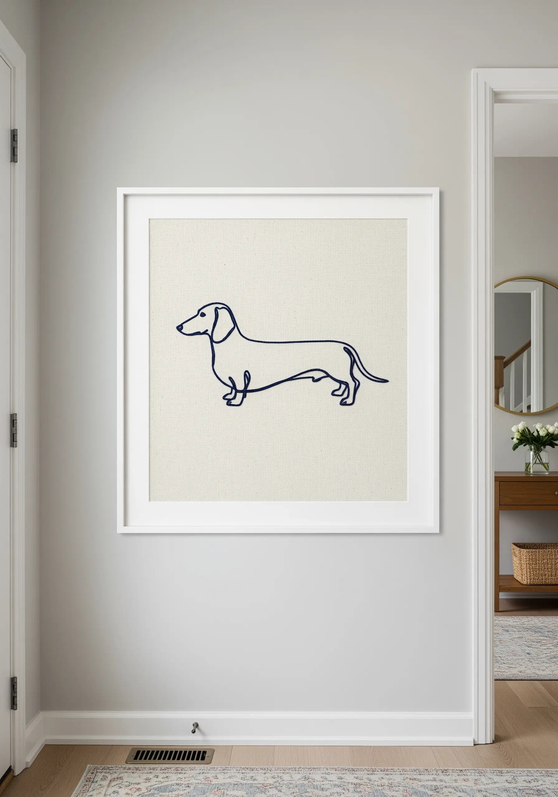 A continuous line embroidery of a dachshund in dark blue thread on off-white canvas.