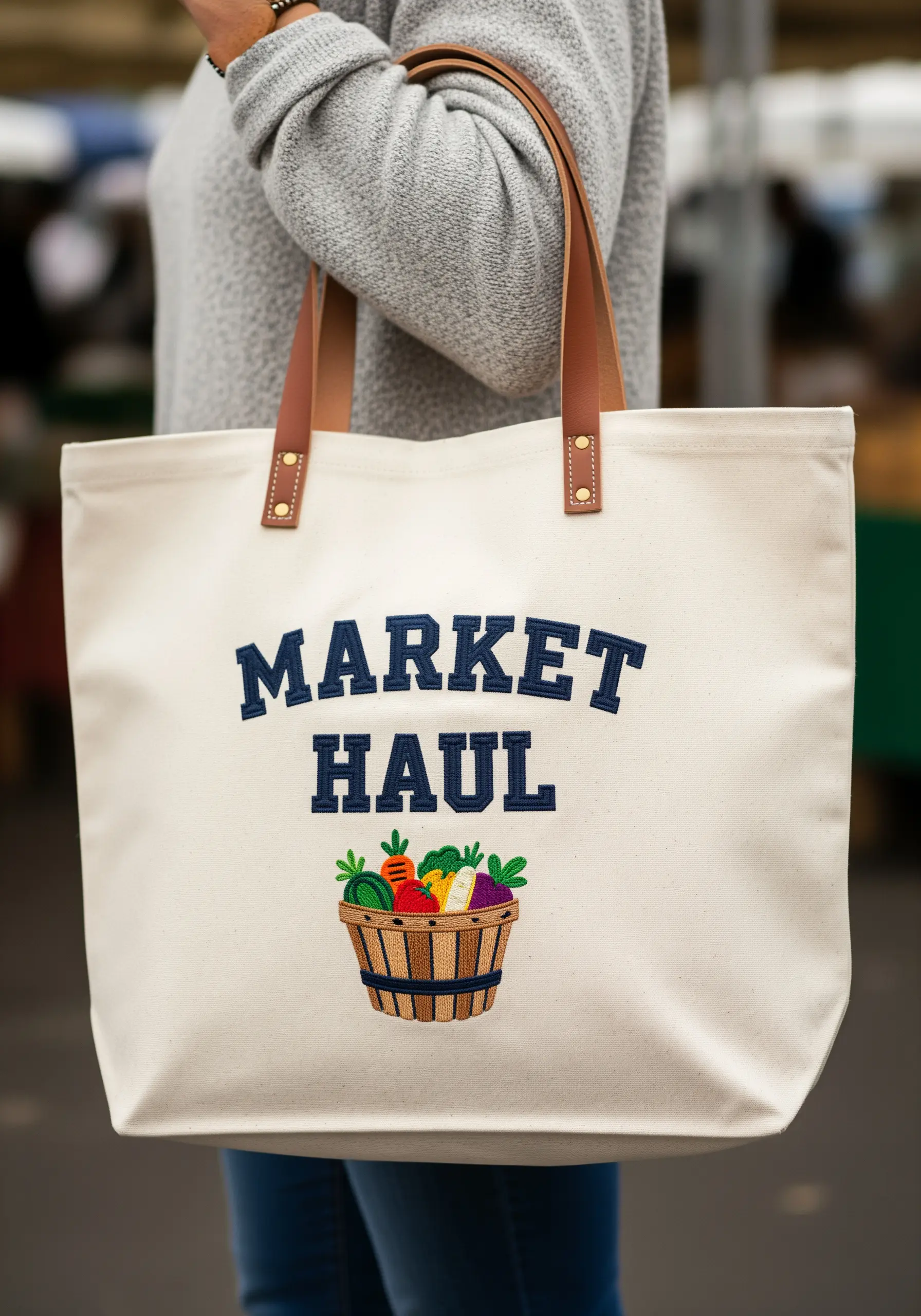 Canvas tote with 'Market Haul' in block letters above a basket of embroidered vegetables.