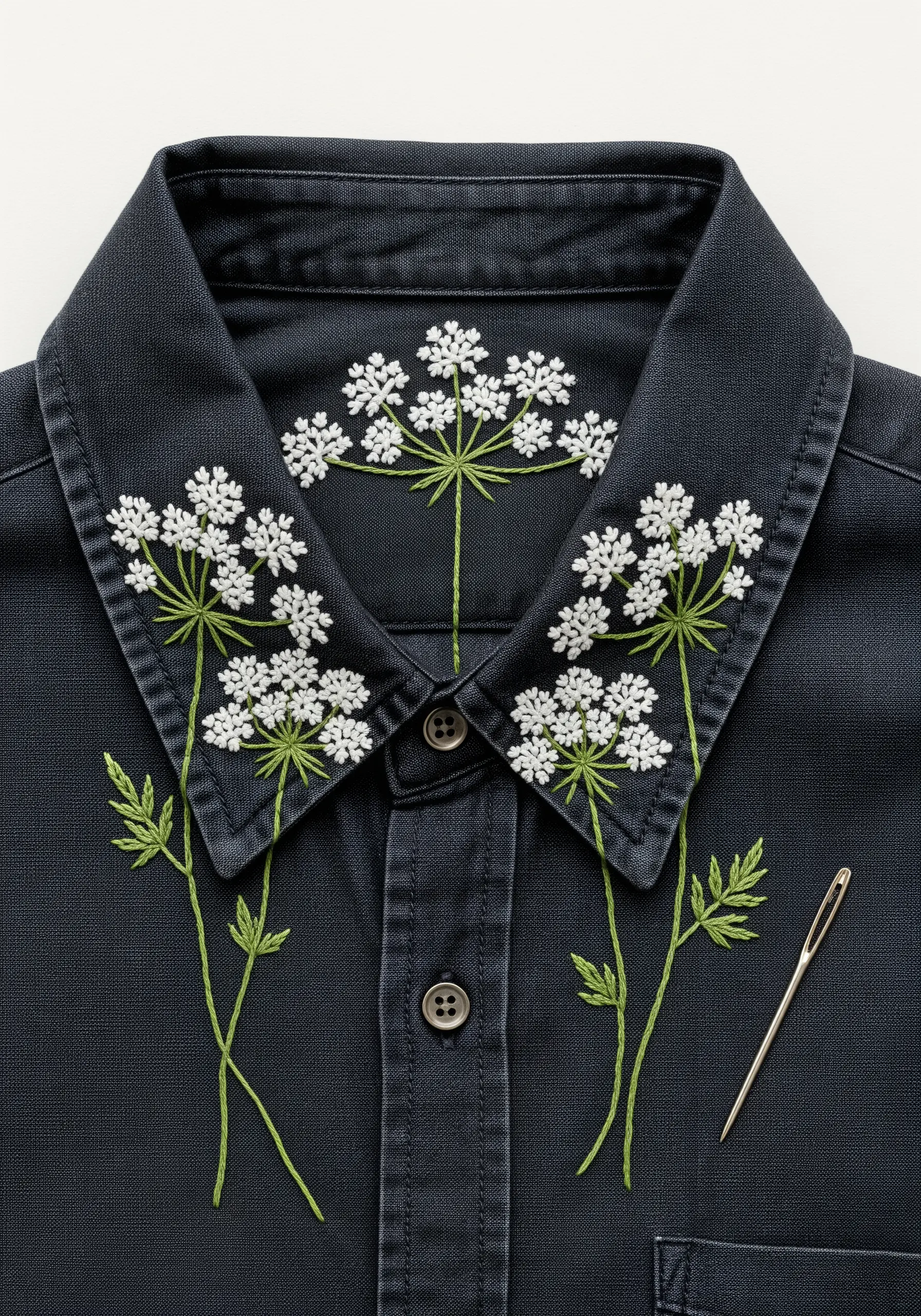 Delicate white Queen Anne's Lace flowers embroidered around the collar of a dark shirt.